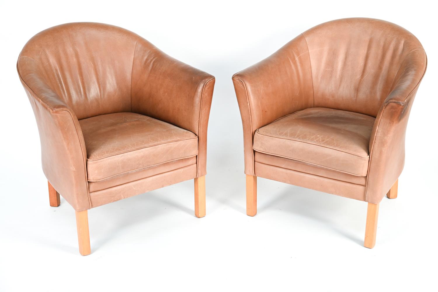 A pair of Danish mid-century armchairs by Mogens Hansen upholstered in leather.