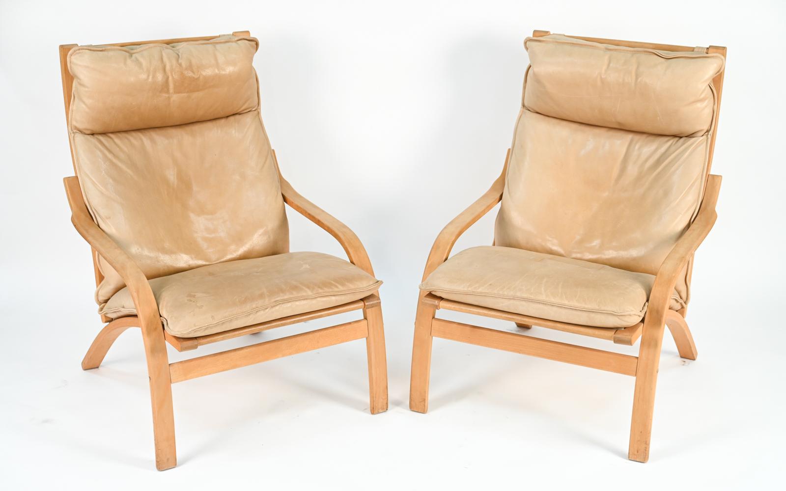 A pair of Danish mid-century armchairs by Mogens Hansen with handsomely patinated butterscotch leather upholstery.