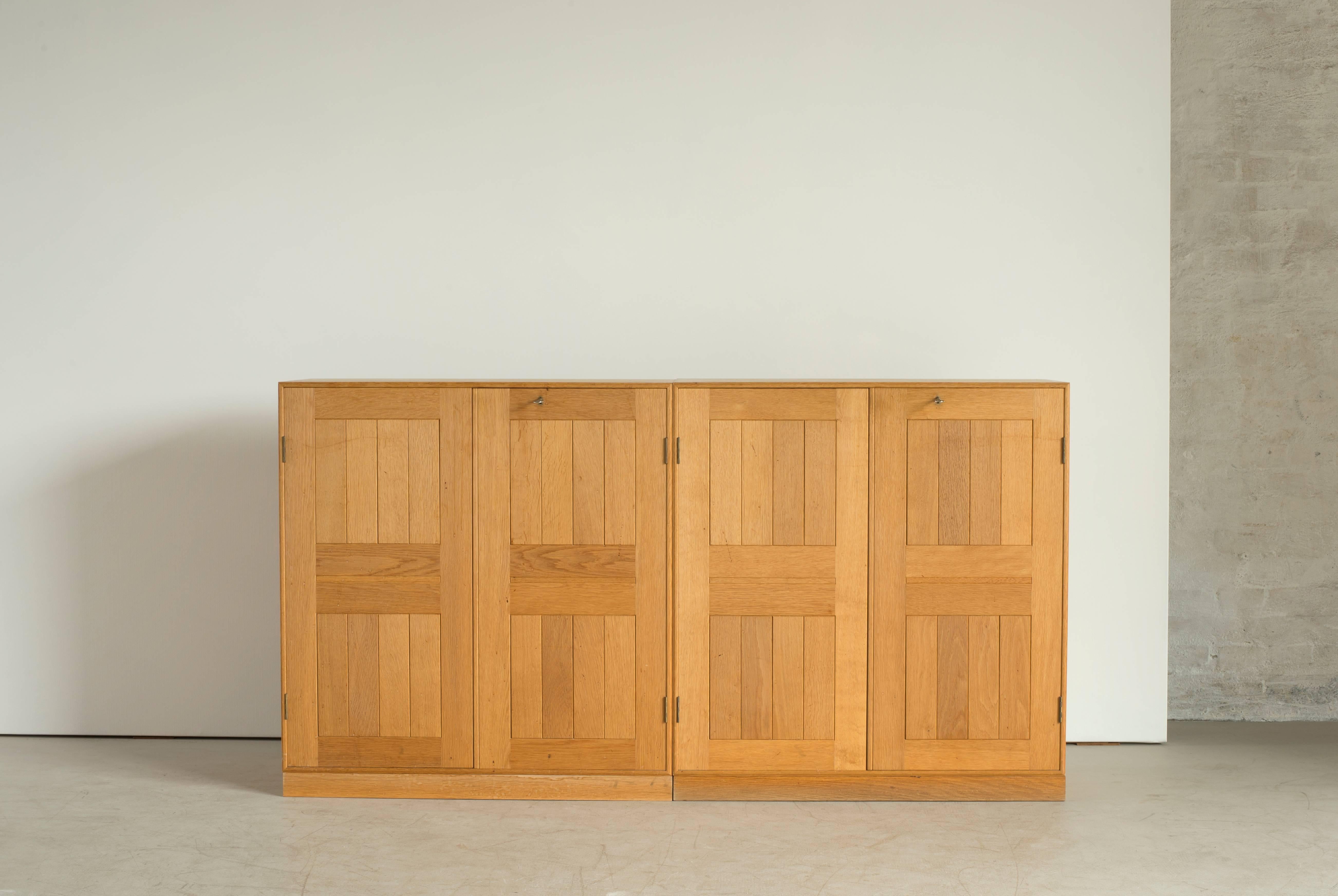 Mogens Koch cabinets and bookcases in oak and maple. Executed by Rud. Rasmussen.

Reverse with paper labels ‘RUD. RASMUSSENS/SNEDKERIER/KØBENHAVN/DENMARK.