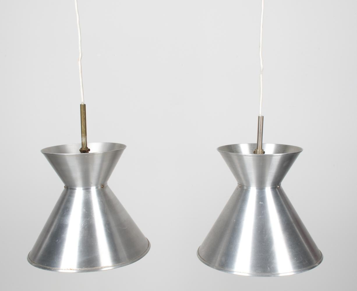 Illuminate your space with a touch of Danish modernism: introducing the Model MK 114 Pendant Lights, a masterful collaboration between Mogens Koch and the iconic Louis Poulsen brand. These pendant lights, sculpted with precision in brushed aluminum,
