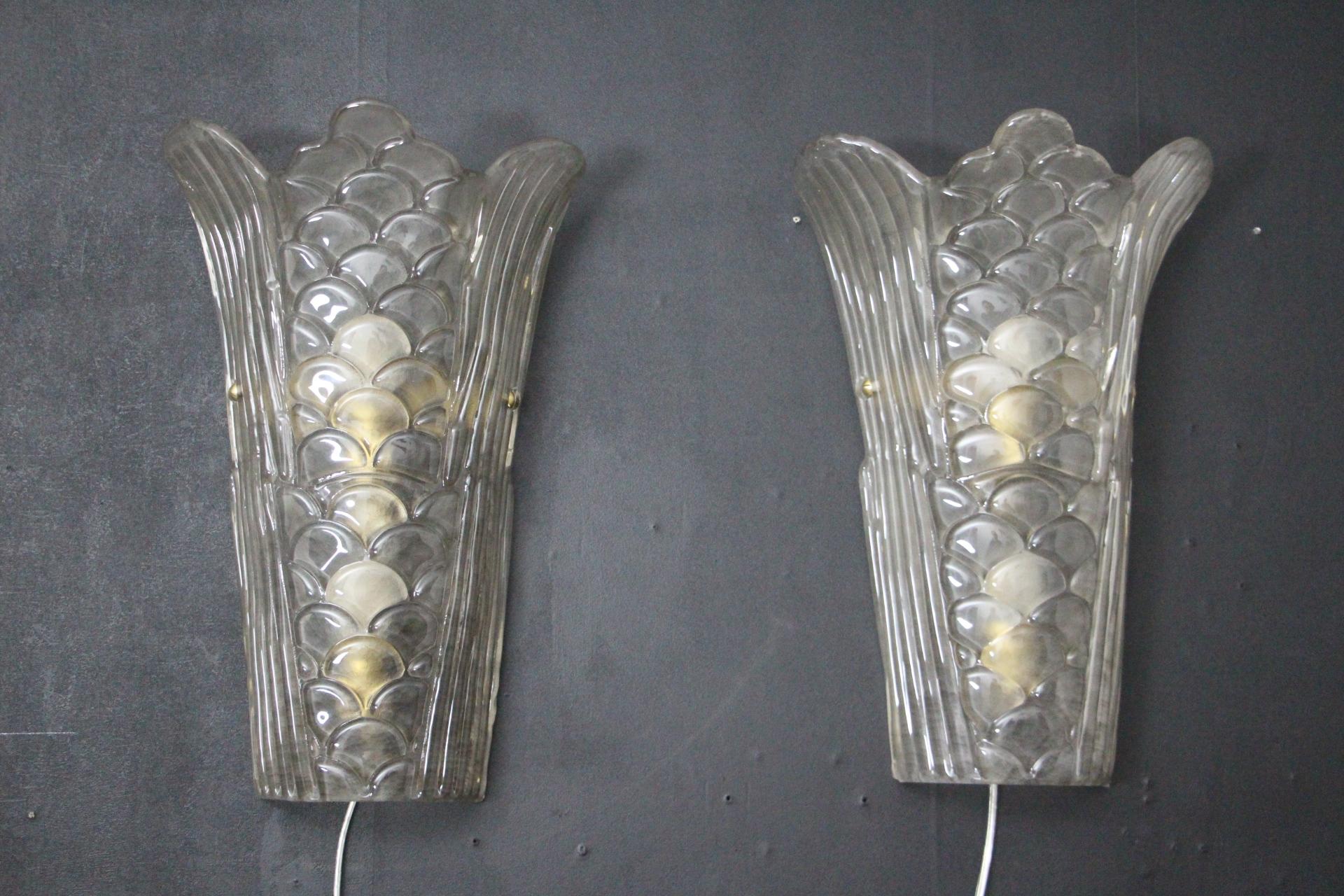 This pair pair of Art Deco wall sconces are in the style of 