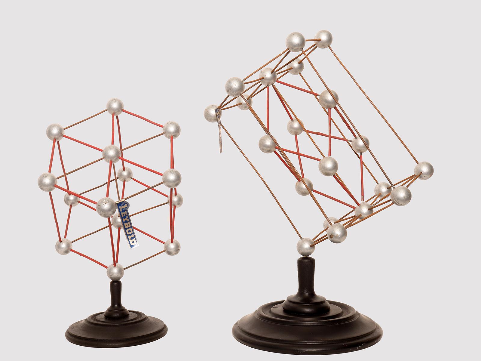 Pair of molecular atomic structure models for chemical didactic use. The spheres are made of painted wood and represent atoms and a molecule. The bases are in turned and ebonized fruit wood. Leybold, Germany, 1940s.