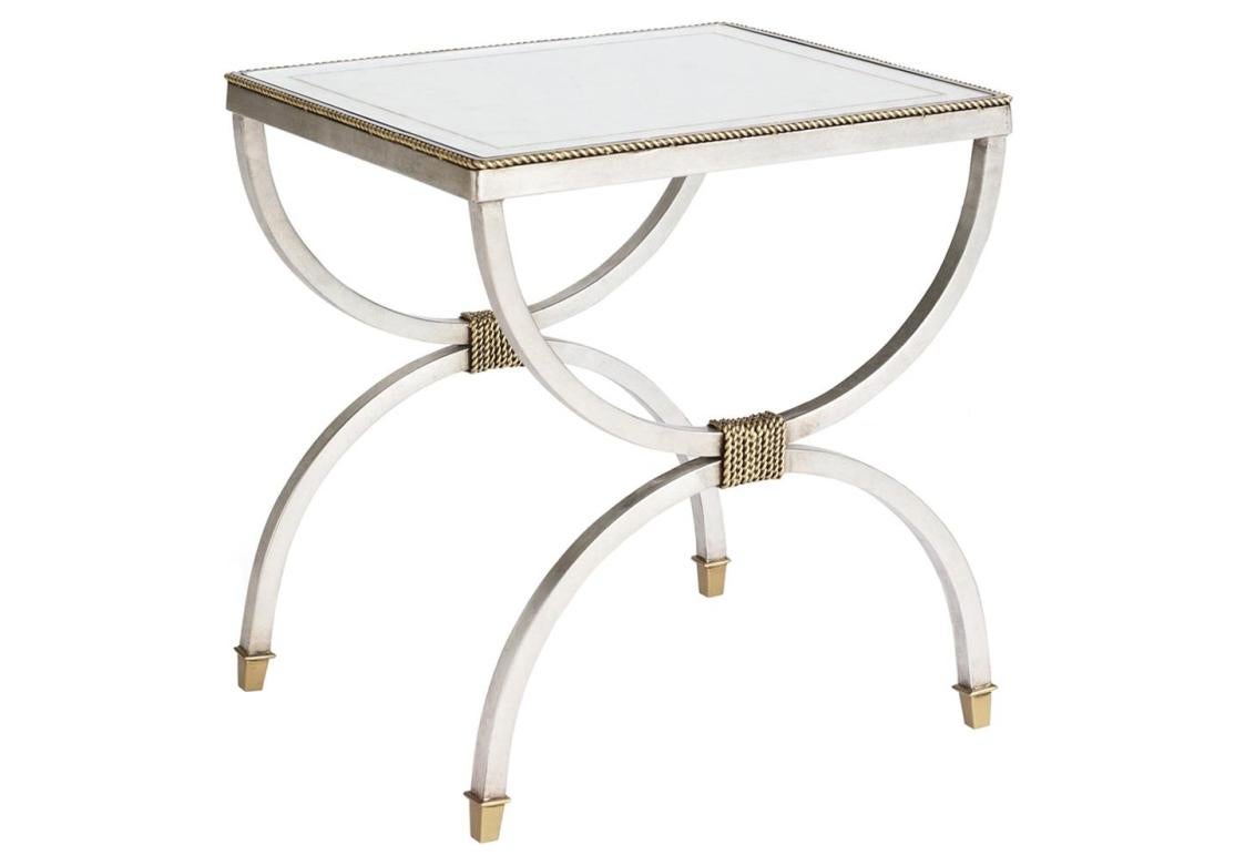 A pair of Century silver eglomise tables with glass top having a gold banding. The tables with reverse 