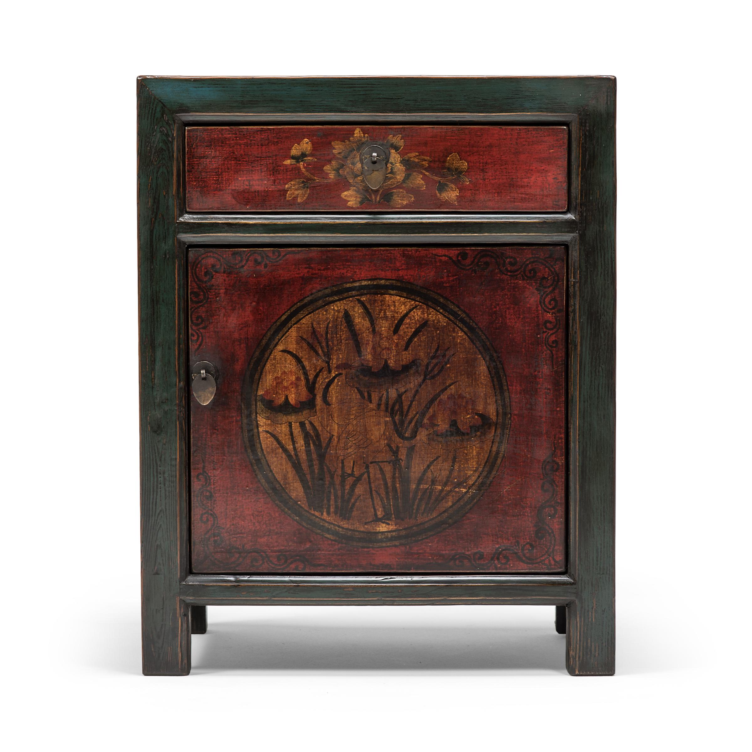 Outlined by simple, blue-green frames, delicate painted floral panels adorn the fronts of these early 20th century chests from Mongolia. The left chest is painted with a graceful heron surrounded by lotus blossoms, a traditional motif that conveys