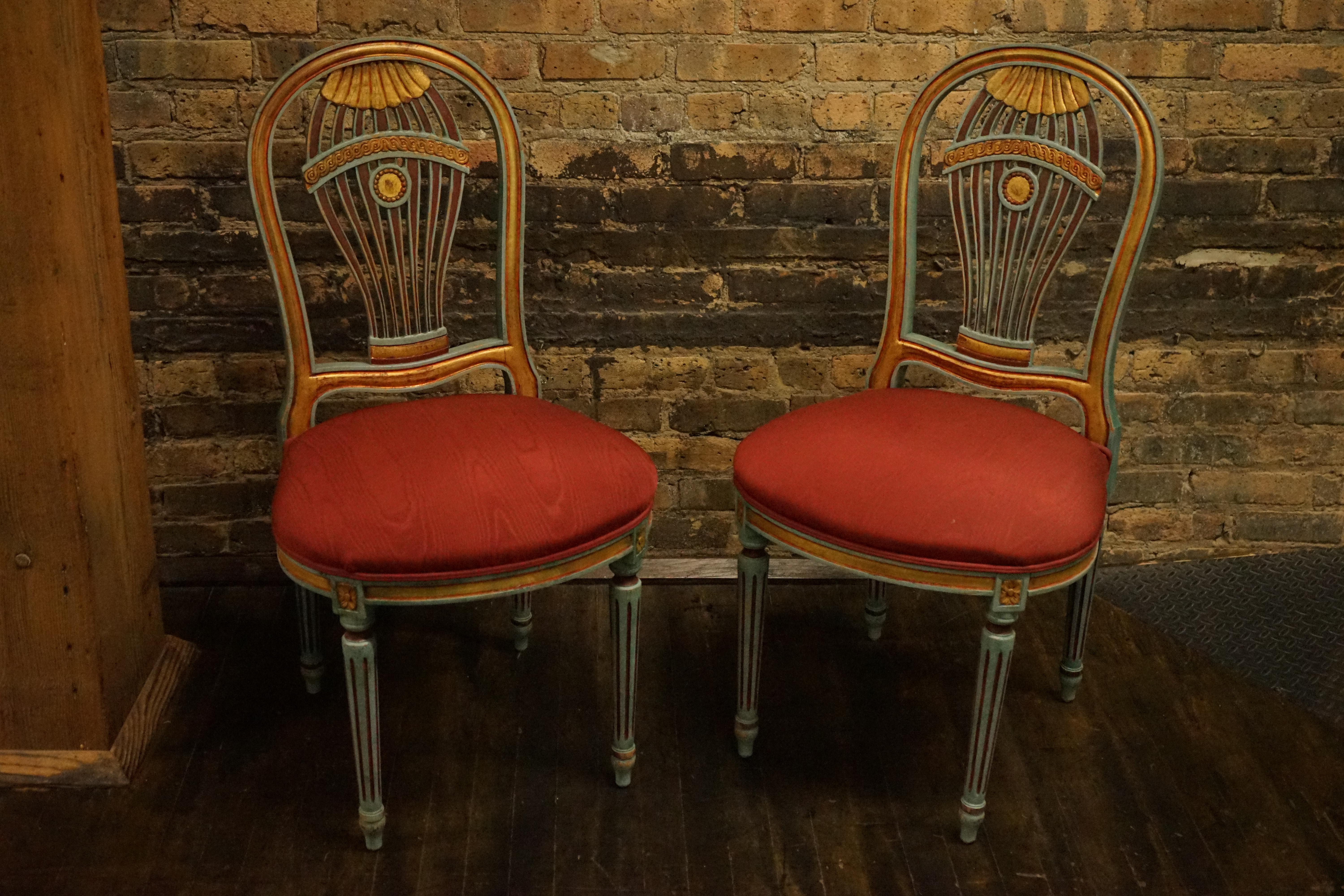 Lovely pair of Louis XVI style Montgolfiere side chairs.  They are characterized by a distinctive hot air balloon-shaped backrest - or Montgolfiere.   The frame of the chair is painted: a soft green with red and gilded accents.  The seat of the