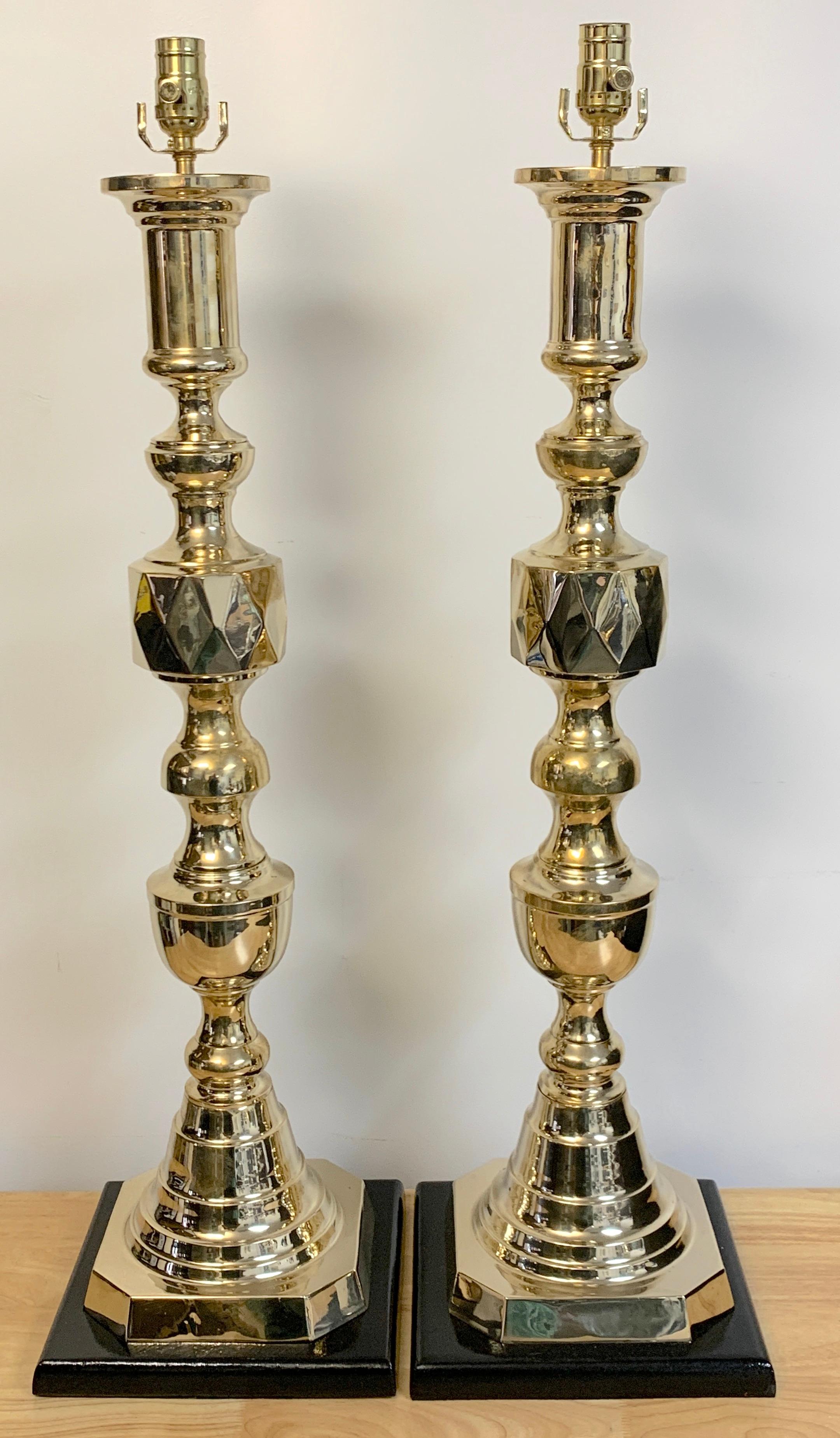 Pair of monumental 'Ace of Diamonds' brass candlestick lamps
Each one of the 'Ace of Diamonds' pattern, the candlestick alone measures 31-Inches high x 8-Inch square base. Raised on 10-Inch square ebonized wood base, 36-Inches high to the top of