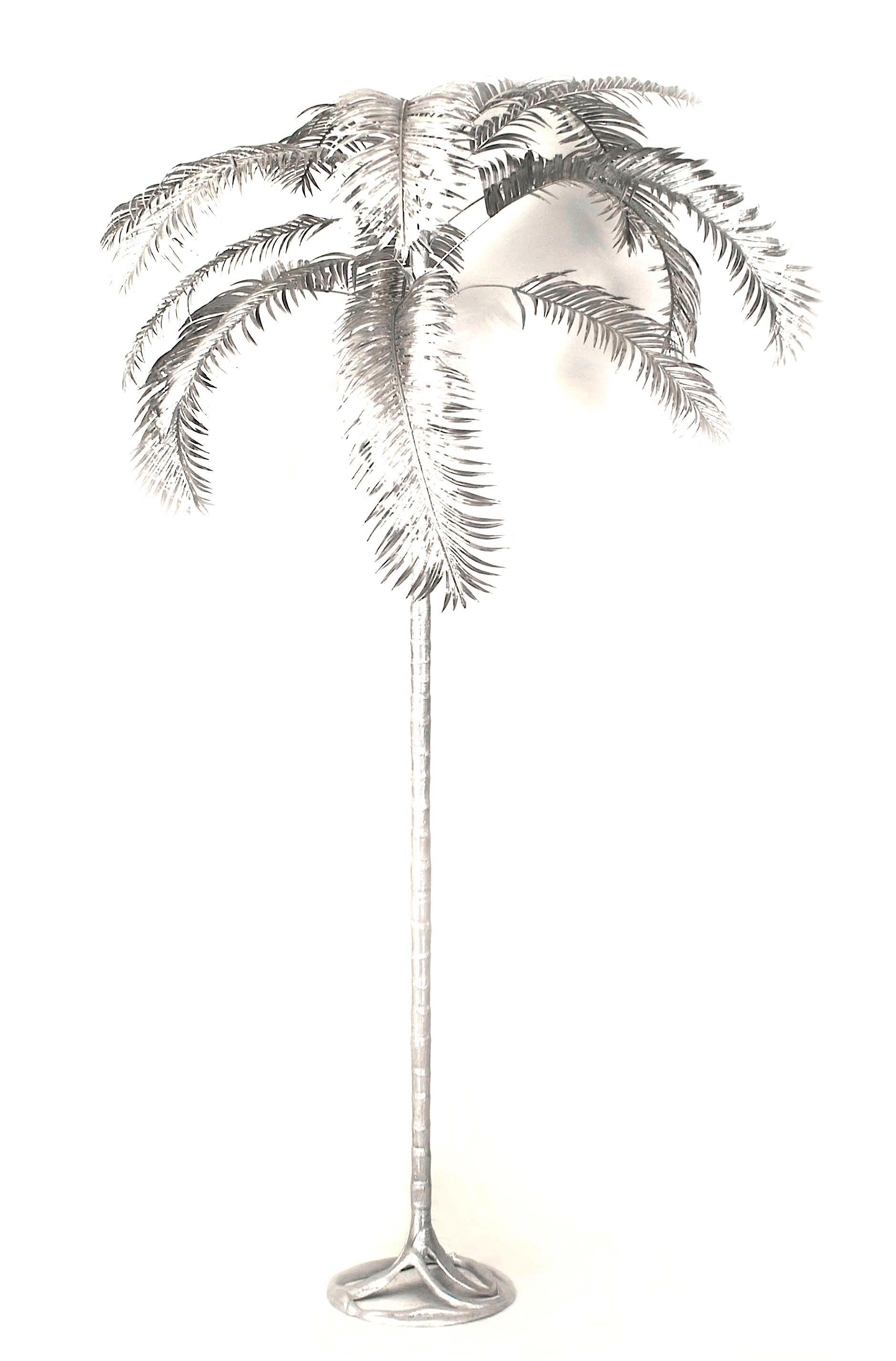 Pair of American aluminum palm trees with a spread of leaves emanating from a tiered shaft on a round molded base (signed Arthur Court, circa 1982.).


In 1966 Arthur opened his own design firm and first showroom in San Francisco at 10 Hotaling