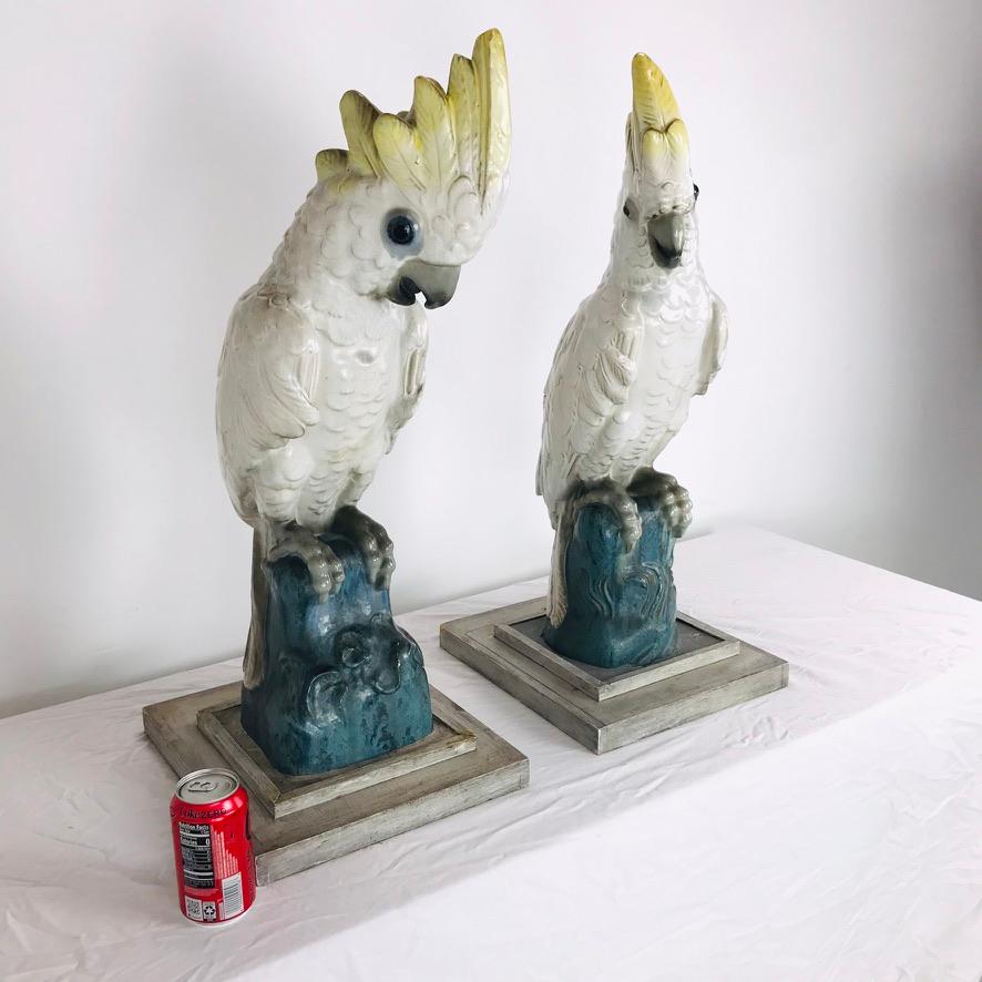 Remarkable pair of rare ceramic crested cockatoo statues. Inspired by the art of Edward Lear and John James Audubon, these large sculptures had bases added on and were used as table lamps in the mid 20th century. The square wood and concrete bases