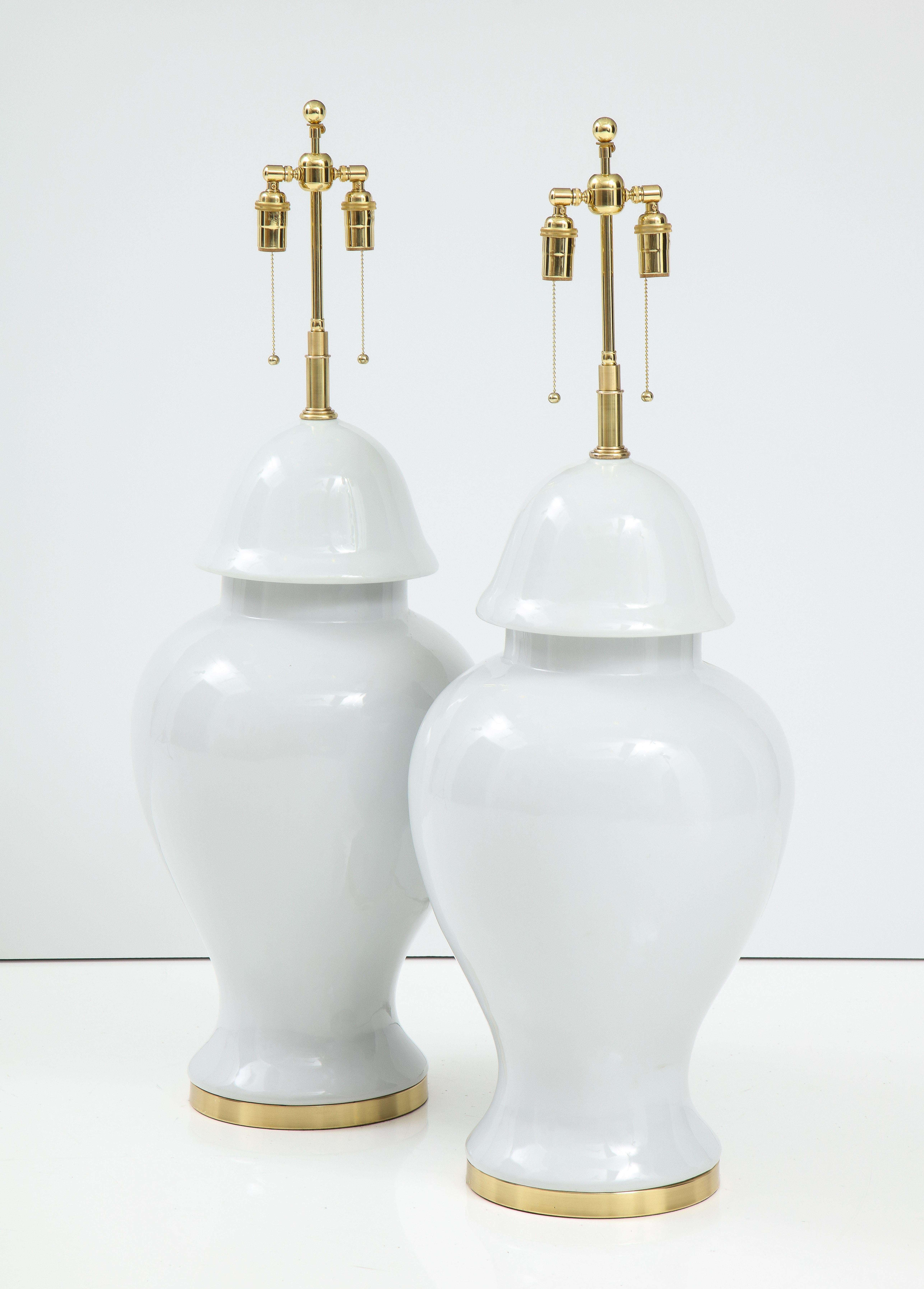 Monumental pair of blanc de chine ginger jar lamps.
The lamp bodies sit on polished brass bases and they have been
Newly rewired with adjustable polished brass double clusters that take
standard size light bulbs.
The overall height to the finial is