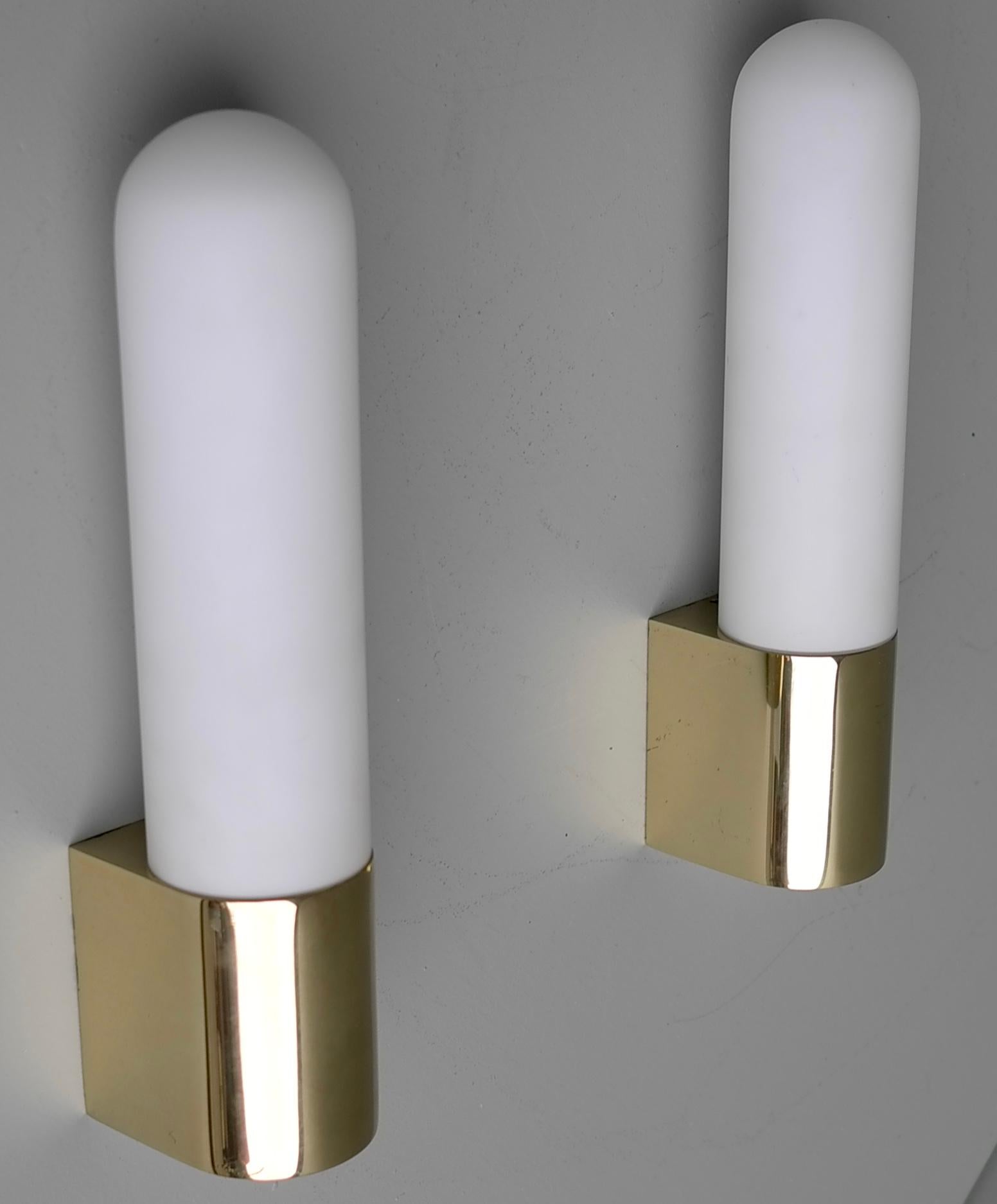 Pair of monumental brass and opaline glass wall lamps, 1970s.