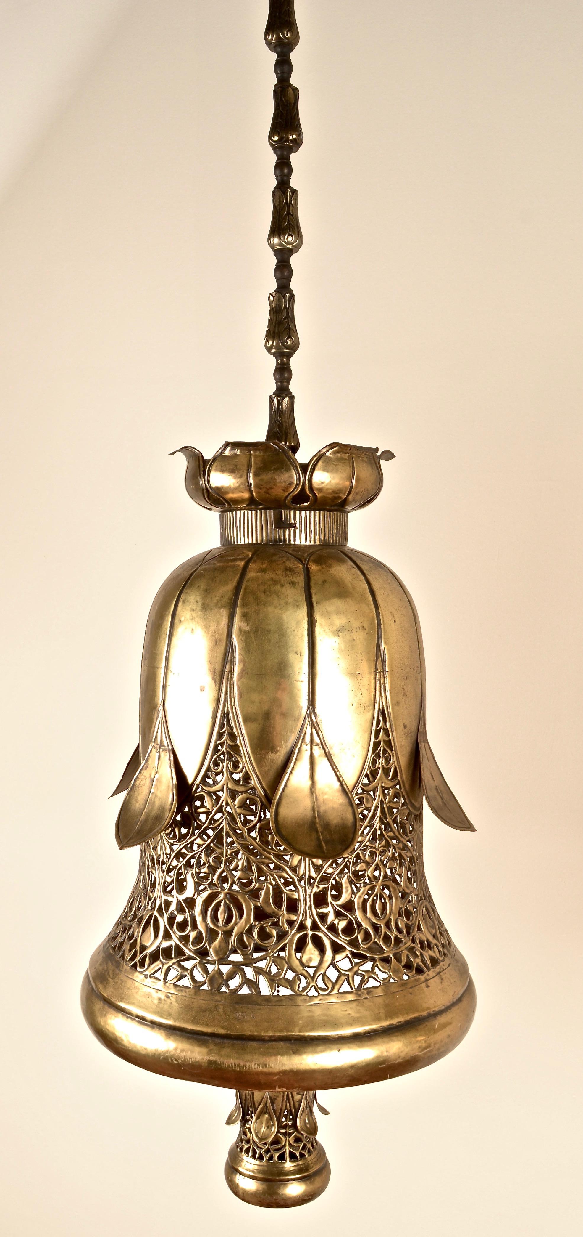 A pair of large pendants, solid brass featuring design details: great bell shape, figured and pierced sides, lotus flower design tops, molded drop chains, mini-replica on/off pulls, and best of all terrific size. The 