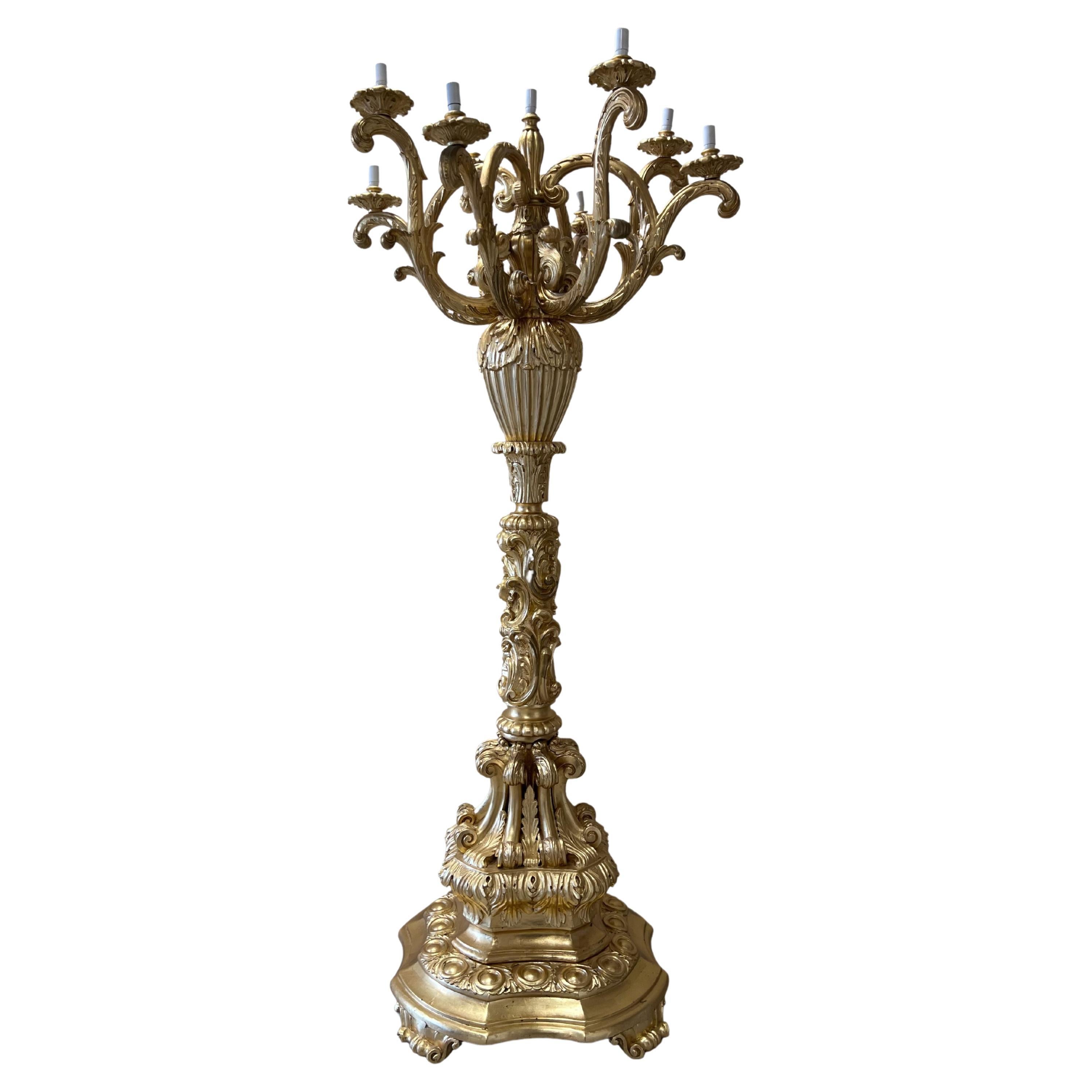 Step into a realm of unparalleled elegance and sophistication with this exclusive pair of Monumental Carved Wood Candelabra. Meticulously crafted by skilled artisans, these extraordinary masterpieces boast intricate carvings that exude a sense of