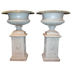 Pair of Monumental Cast Iron Campagna Form Garden Urns on Decorated Pedestals