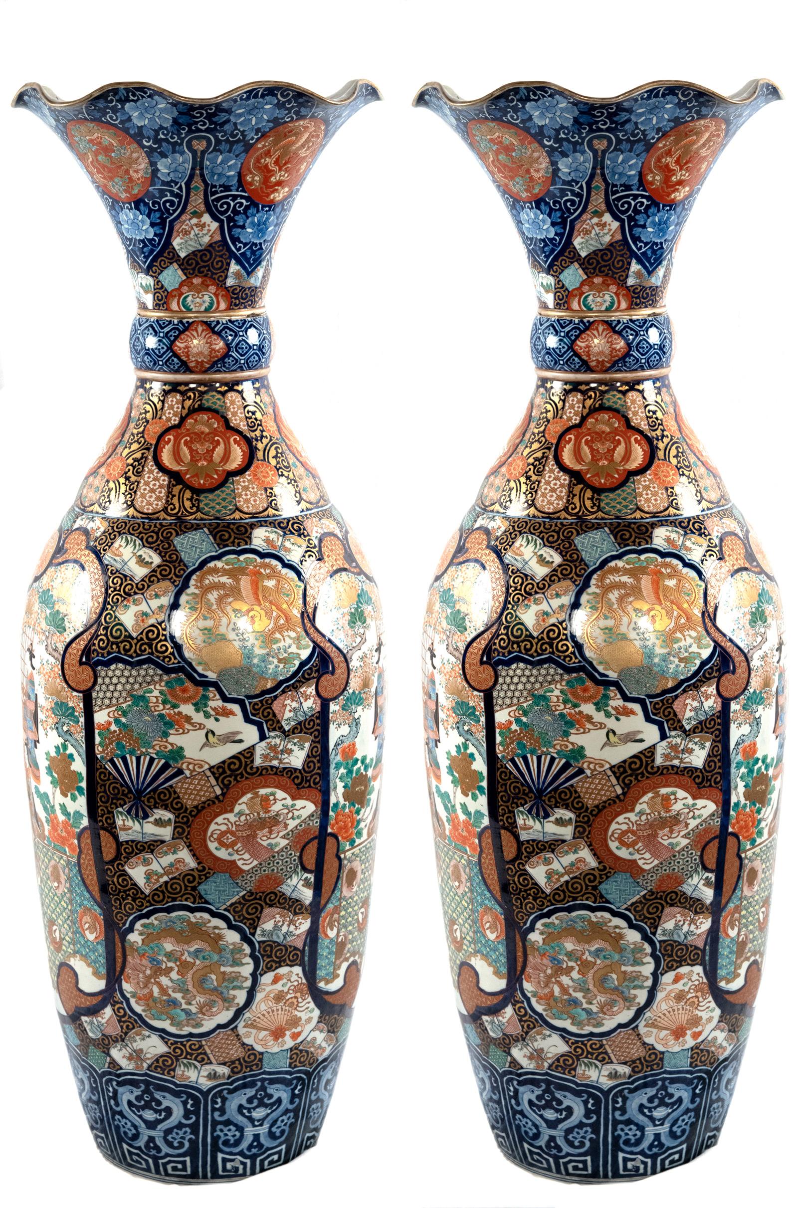 Two very fine and large Imari-style (i.e. cobalt blue, manganese red brown, copper sulfate green, and gold) porcelain vases and featuring scenes from courtly life.