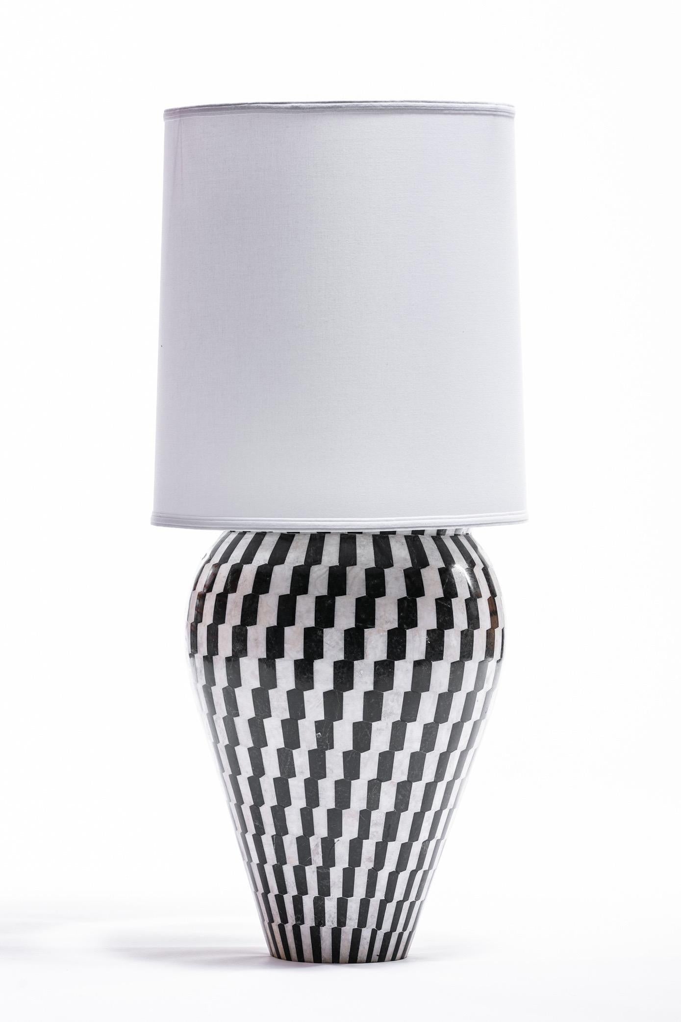 Pair of large scale Kelly Wearstler tessellated marble and onyx geometric urn shaped lamps. Black and white geometric tiles of marble and onyx cover the neoclassical forms. Dramatic and chic, elegant but playful. These lamps were custom designed for