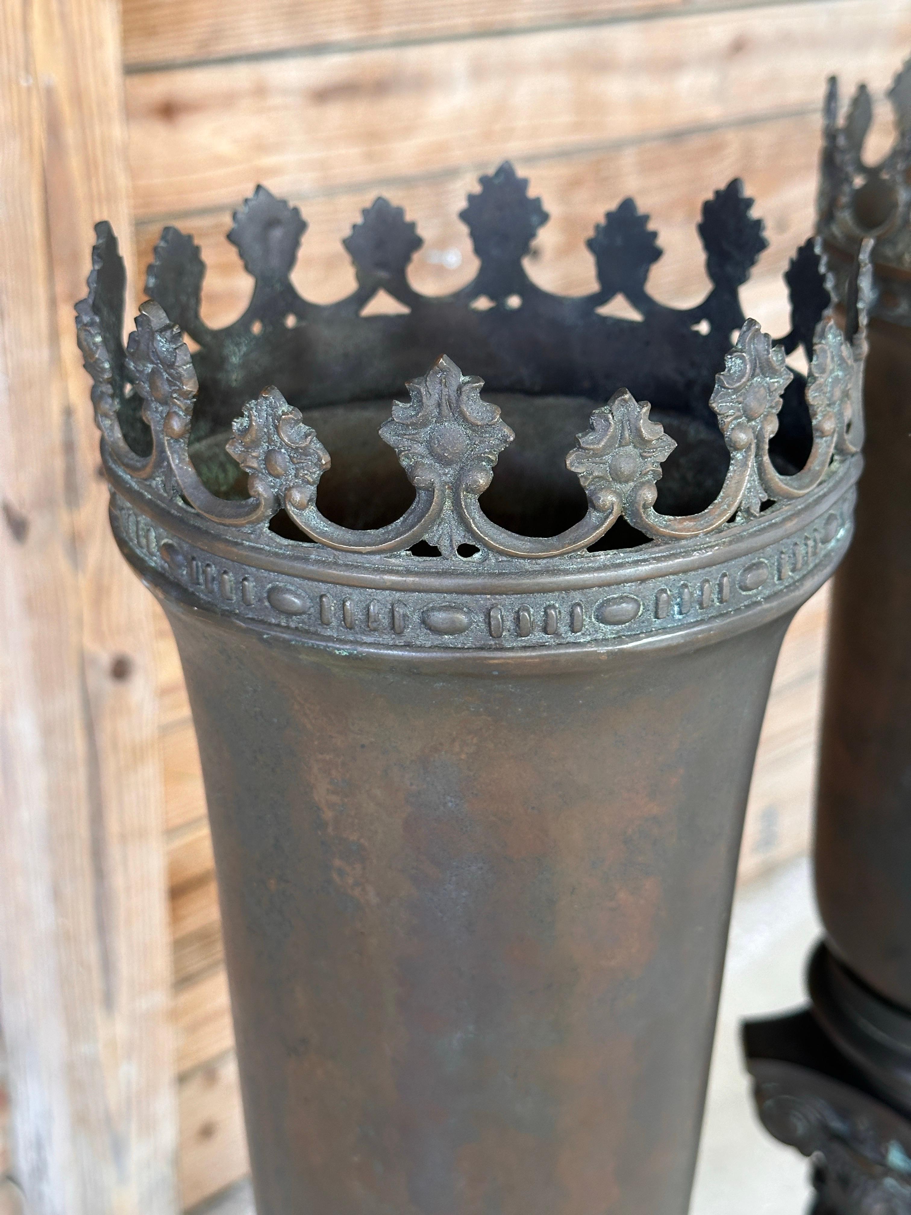An extraordinary pair of early 20th-century neoclassical torchère-style lamps, featuring stunning bronze and heavy marble bases.
These grand statement pieces showcase intricate Corinthian-style capitals, richly patinated bronze urn tops with an