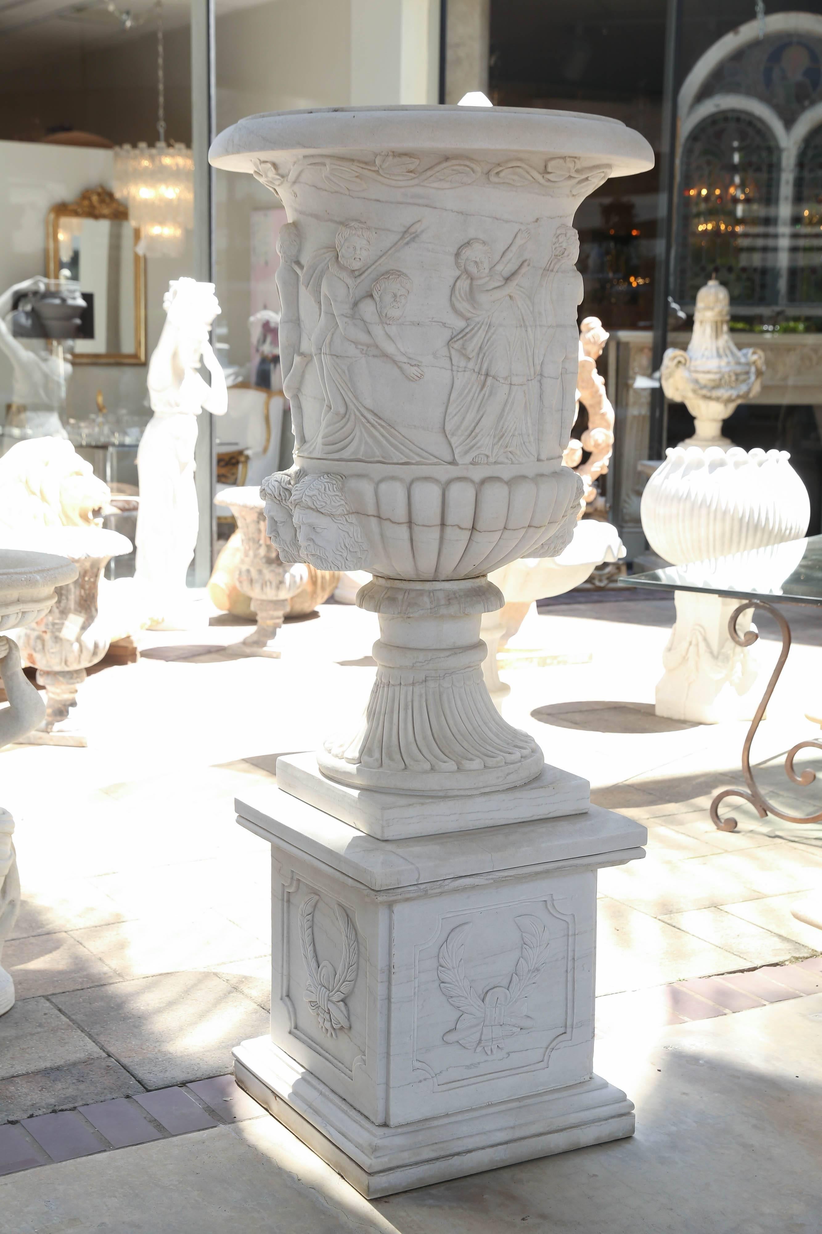 Large and beautifully carved planters resting on pedestals
of the same marble. The planters carved with lovely
classical figures. Carved both wind faces adorn each side.