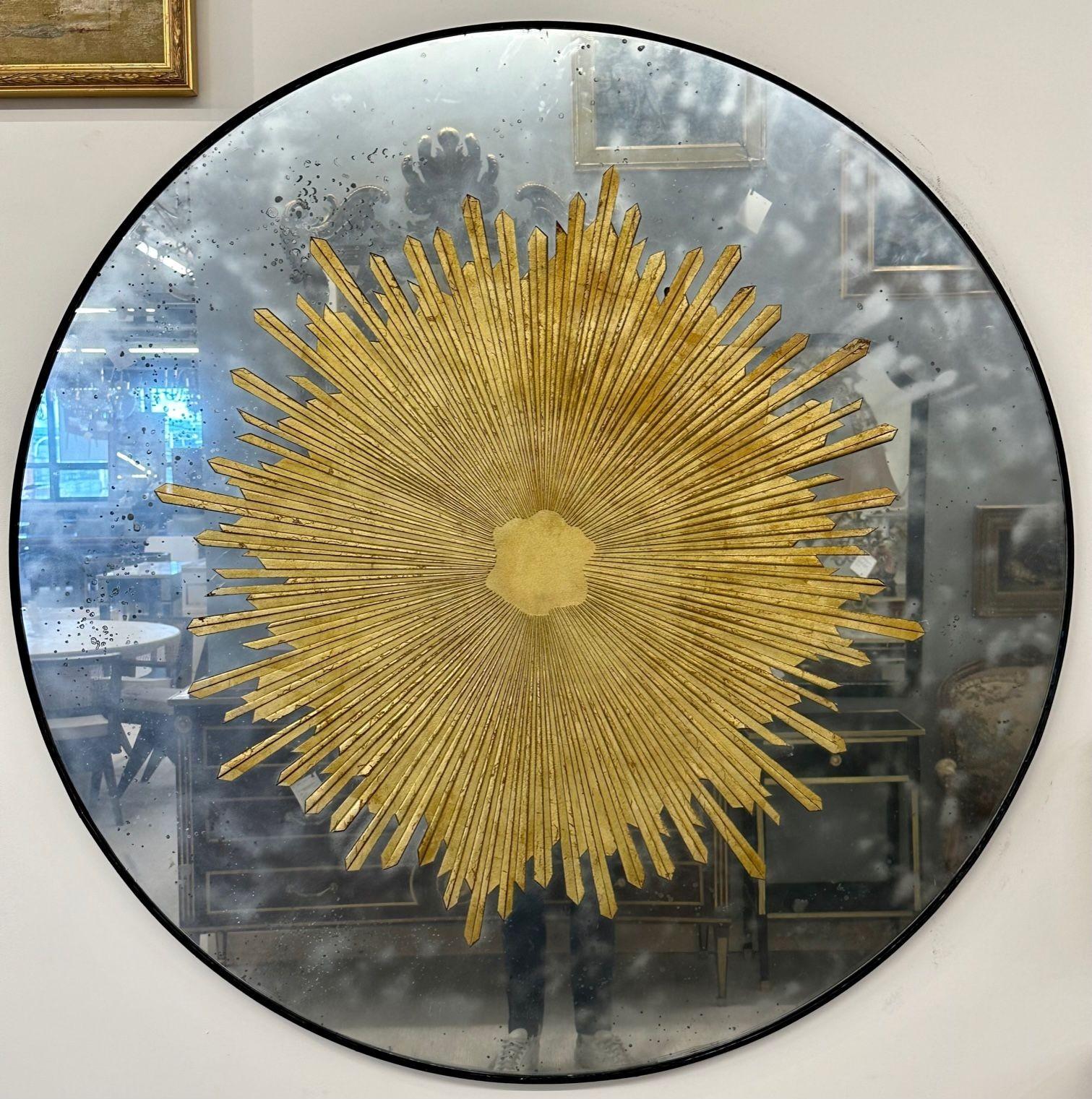 Pair of Monumental Gilt gold and silver glass sunburst mirrors, Antiqued Mirror
 
A pair of monumental, carved gilt gold and silver glass sunburst wall mirrors or table tops. These spectacular, finely ornamented and antiqued mirrors make a