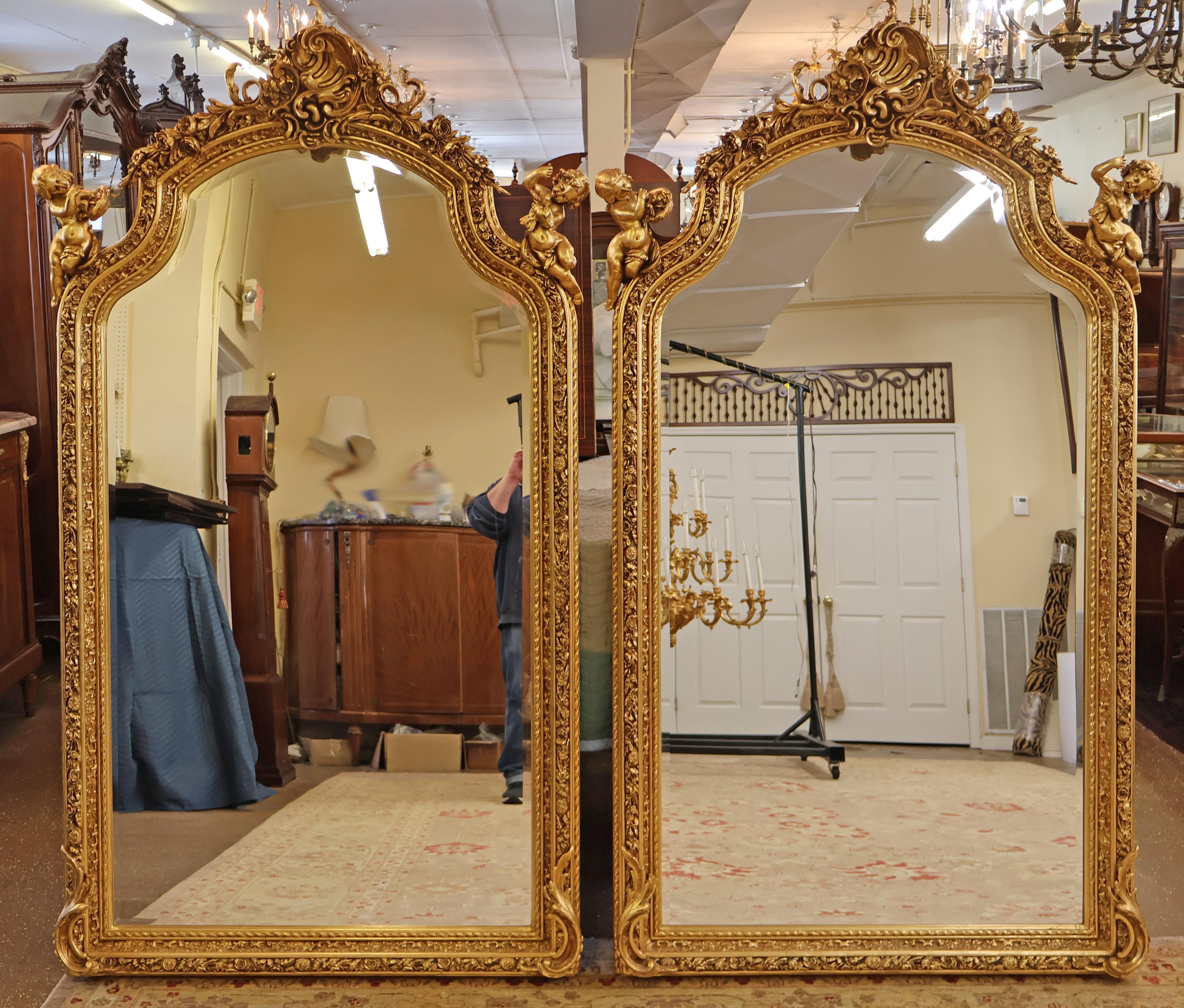 Paire de miroirs biseautés de style Louis XVI français, dorés et ornés d'un chérubin putti 

Dimensions : 85