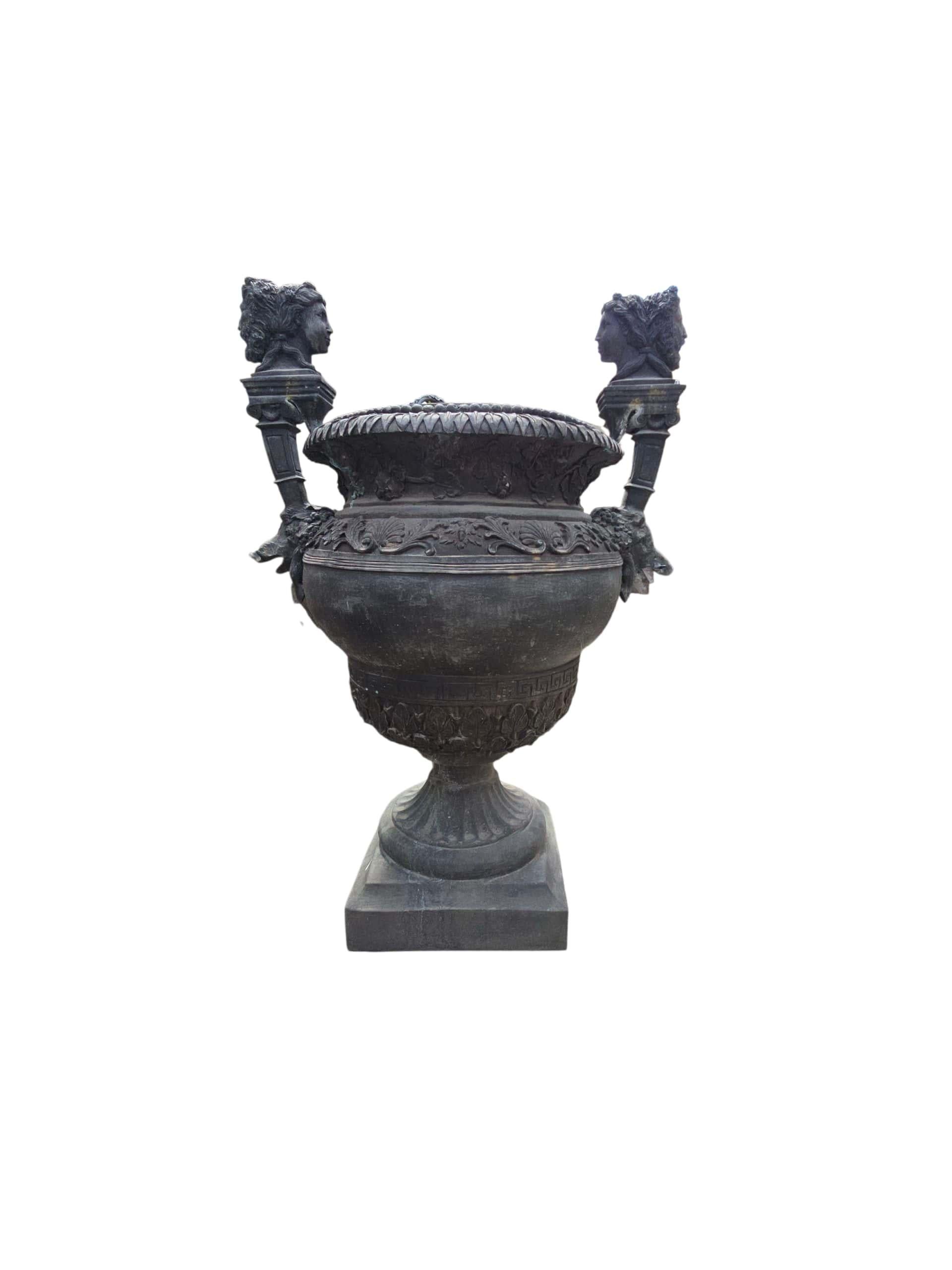 Magnífica pareja de urnas monumentales de bronce, ricamente decoradas y cinceladas a mano con intrincados detalles. Fabricados en el siglo XX, estos jarrones palaciegos presentan motivos clásicos, relieves ornamentales y proporciones elegantes, que