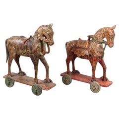 Paire de chevaux monumentaux indiens en bois sculpté polychrome montés sur roues, XIXe siècle.