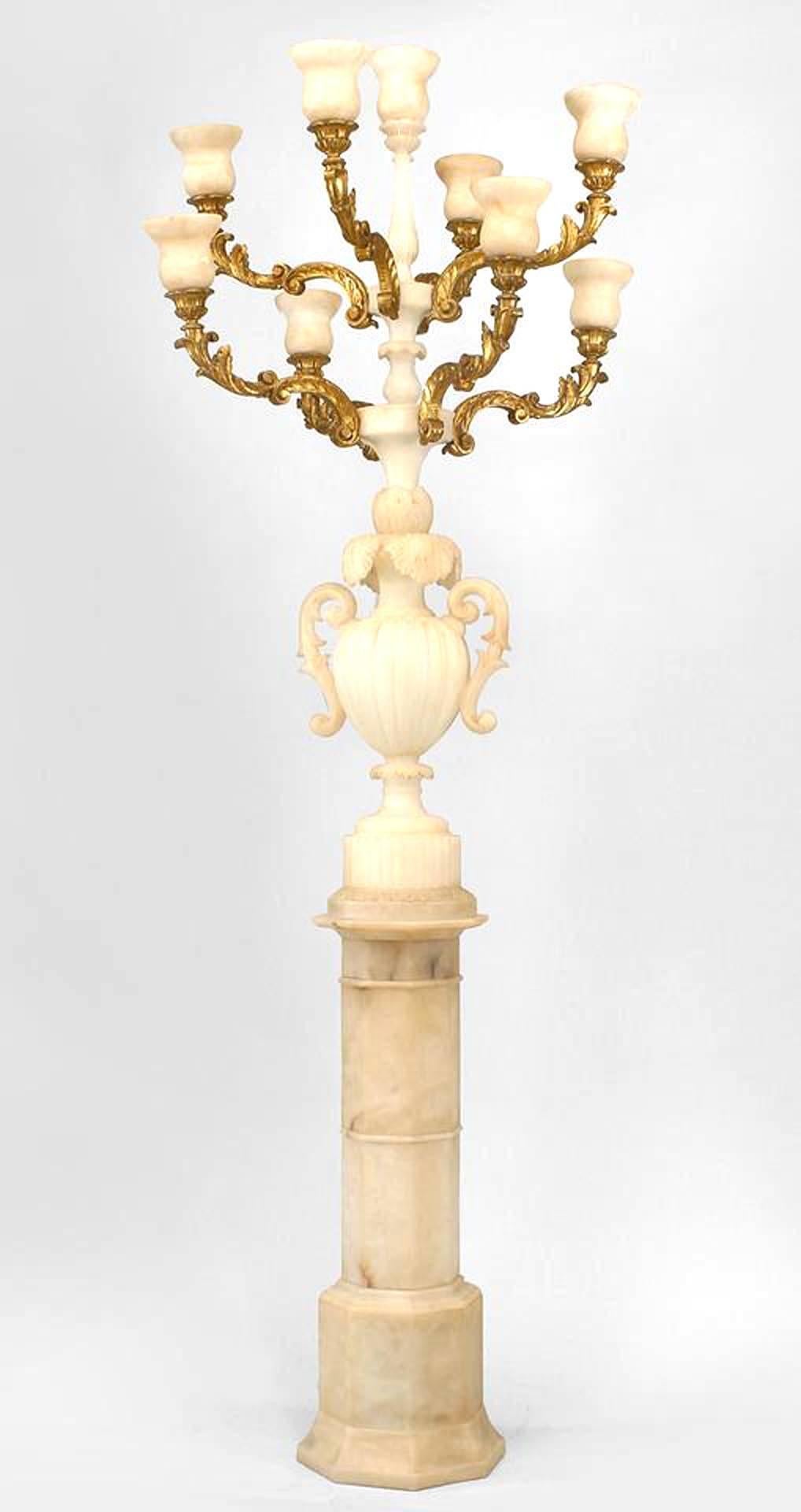 Pair of Italian Rococo style (dated 1932) white alabaster 9 light floor torchiere with a carved urn with handles supporting 8 gilt carved arms all mounted on a pedestal base (PRICED AS Pair).
