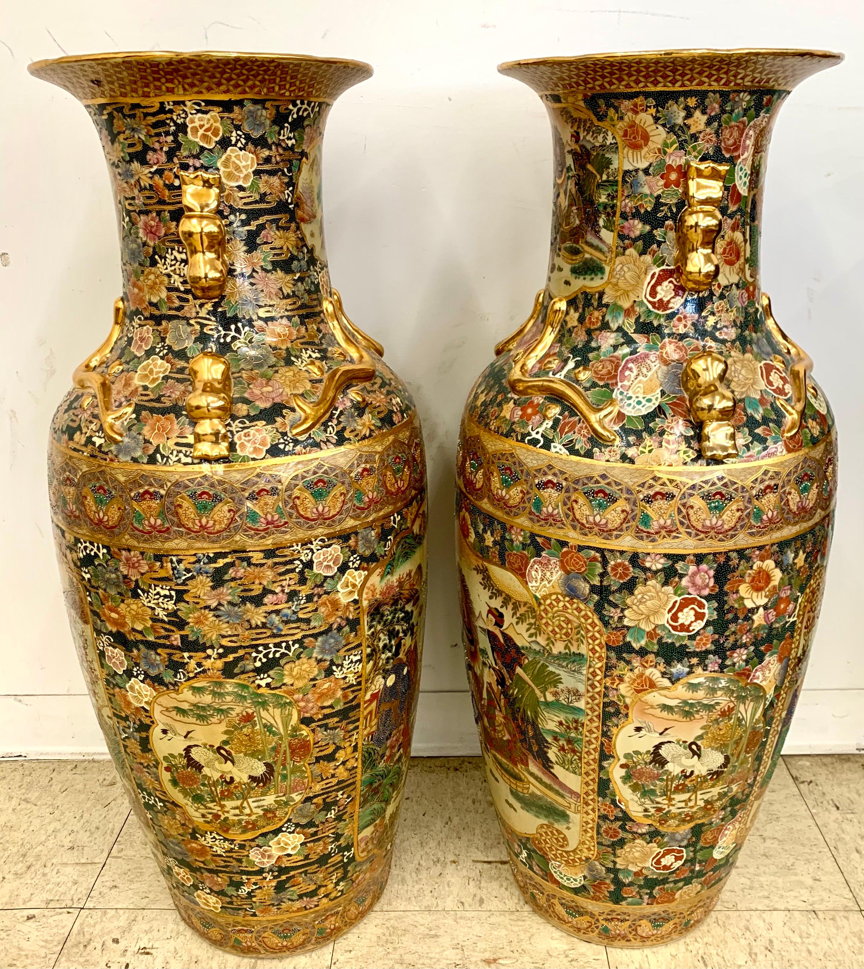 Stunning Japanese Satsuma porcelain vases having gilded decoration and intricately detailed hand painted inset panels depicting landscape scenery with mortals and samurai warriors.