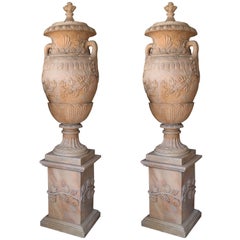 Pair of Monumental Marble Urns in Shades of Coral Resting on Pedestals