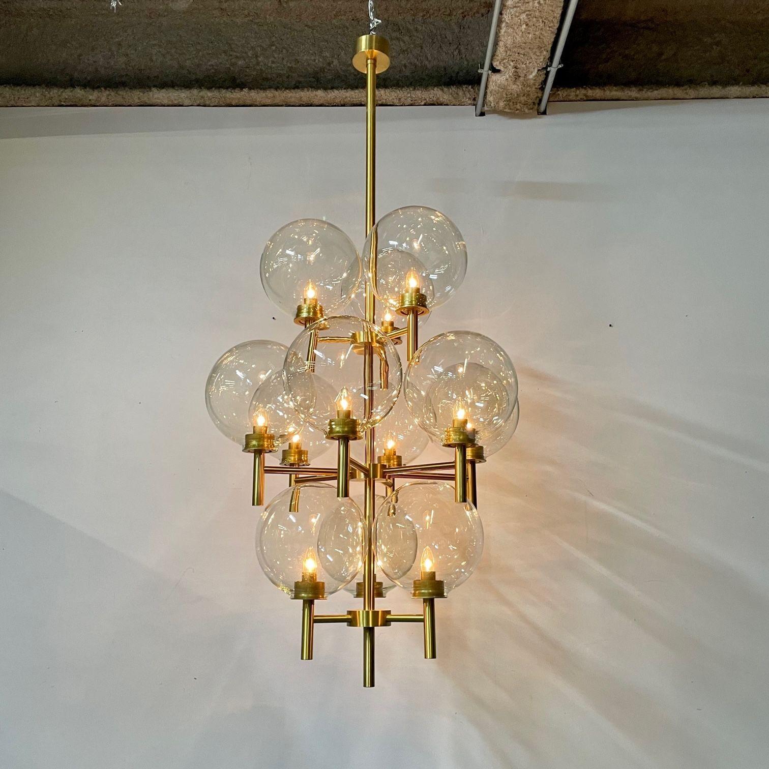 Pair of Monumental Mid-Century Modern Style Chandeliers in Amber Glass and Brass
 
Brass chandeliers with multiple amber globes in the style of Uno & Osten Kristiansson, Sweden, c. 1970s
 
Brass, Amber Glass
2000s