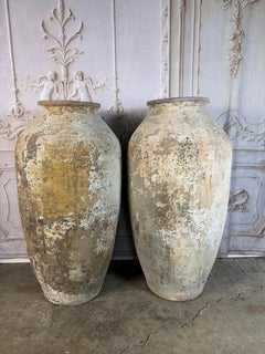 Pair of Monumental Terracotta Olive Jars with Weathered Patina
