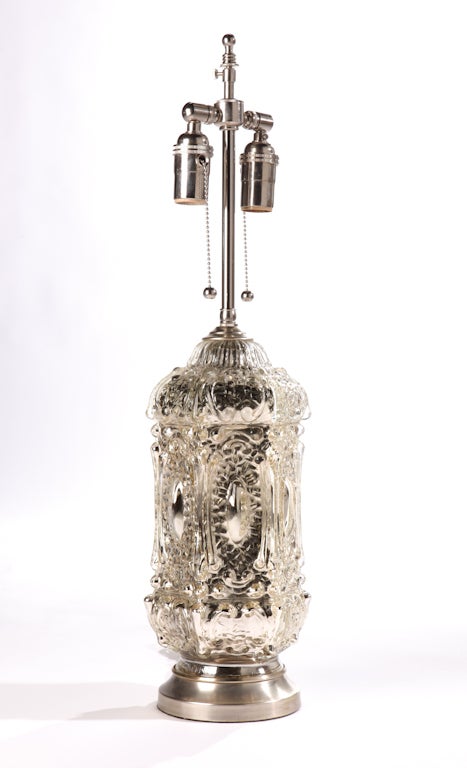 Pair of stylish Moorish design mercury glass lamps, C. 1970.'s.
The lamps have been restored and refitted with new nickel plated solid brass hardware and circular bases. Double socketed, with chain pulls for ease of light control.