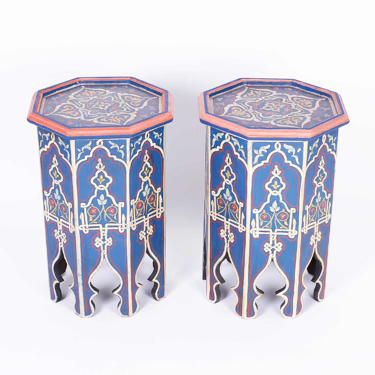 Pair of antique Moroccan wood stands with an octagon form painted with distinctive mediterranean colors in floral designs on the top and sides. The eight legs are separated by graceful Moorish arches.