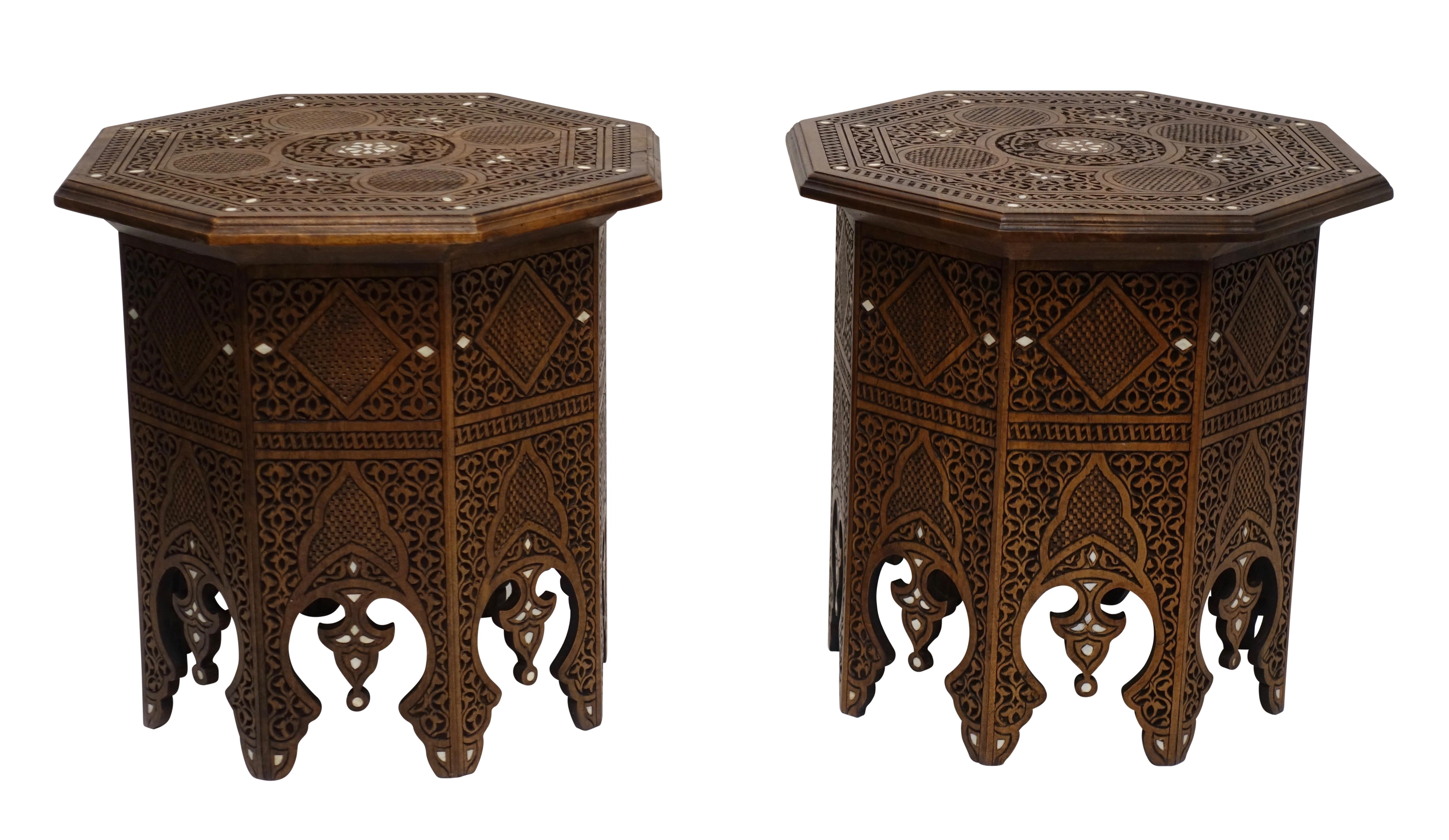 A pair of midcentury Moorish style highly carved tabouret tables with bone inlay detail.
Last half of 20th century.