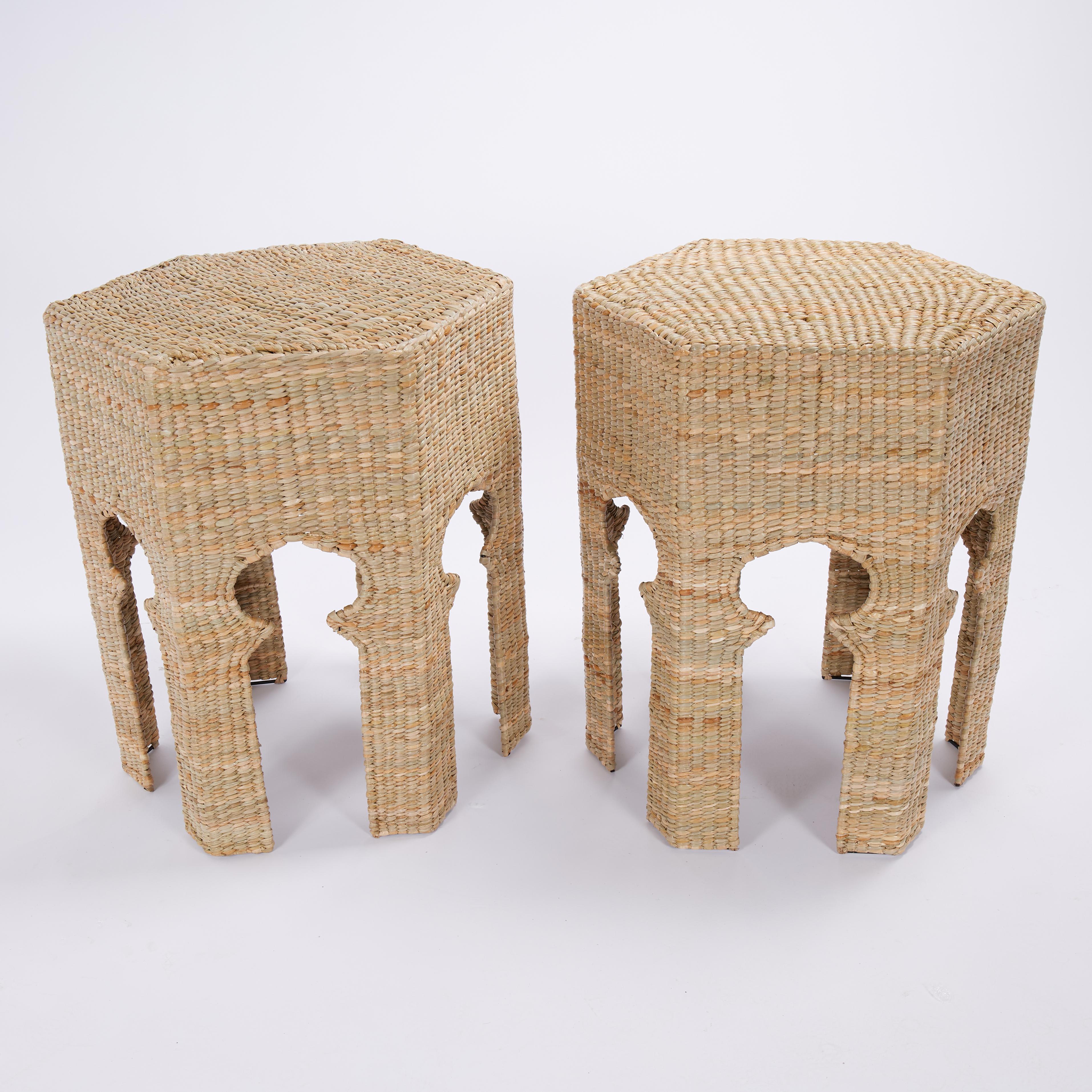 Standout pair of Moroccan style tables or stands handcrafted with a metal frame and expertly covered in woven reed in a hexagon form featuring Moorish style arches between the six legs. Offered from the Flores collection exclusively designed and
