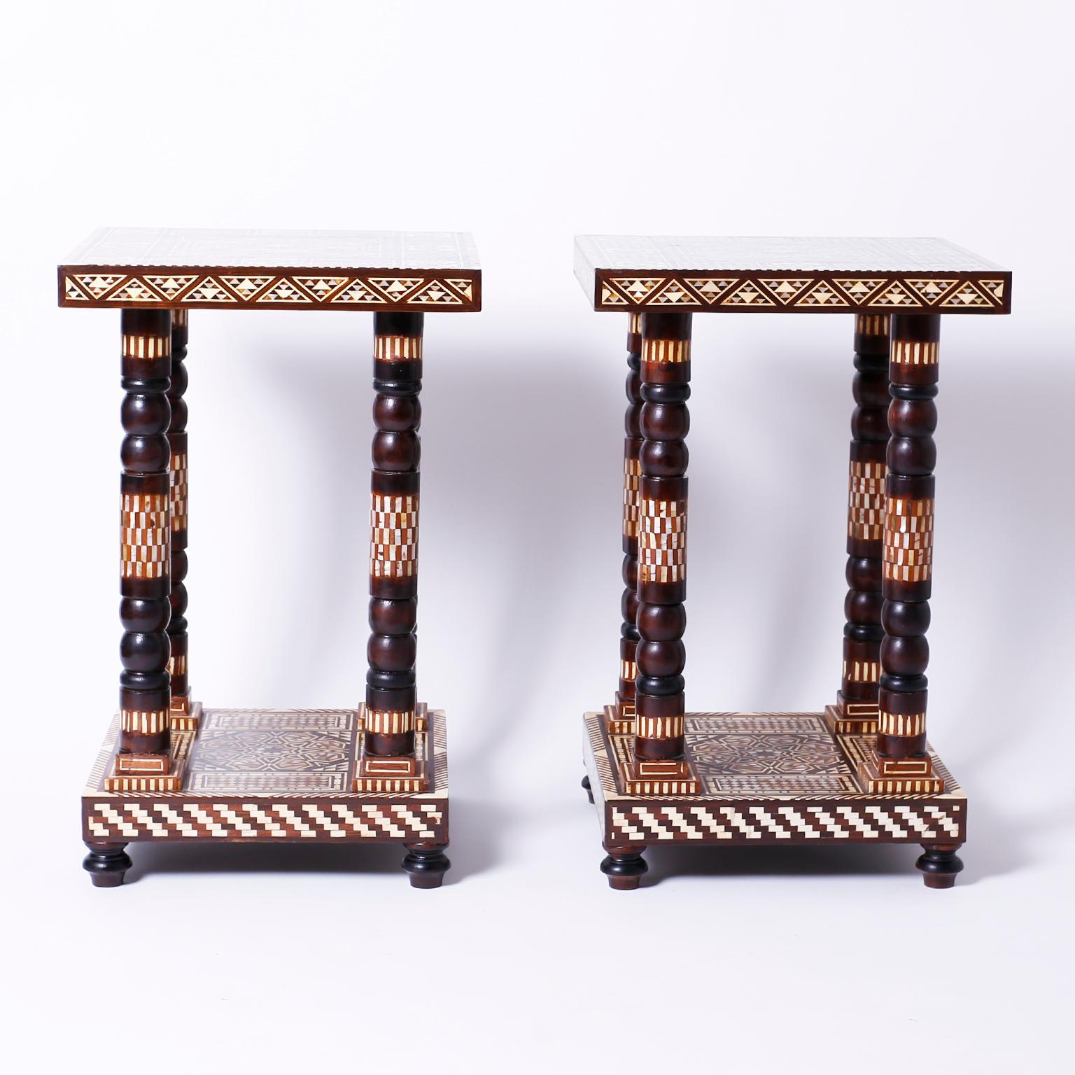 Pair of Moroccan tables or stands with square tops decorated with inlaid mother of pearl, tortoise, bone and exotic hardwoods, supported by four turned and inlaid columns on an inlaid base with turned feet.