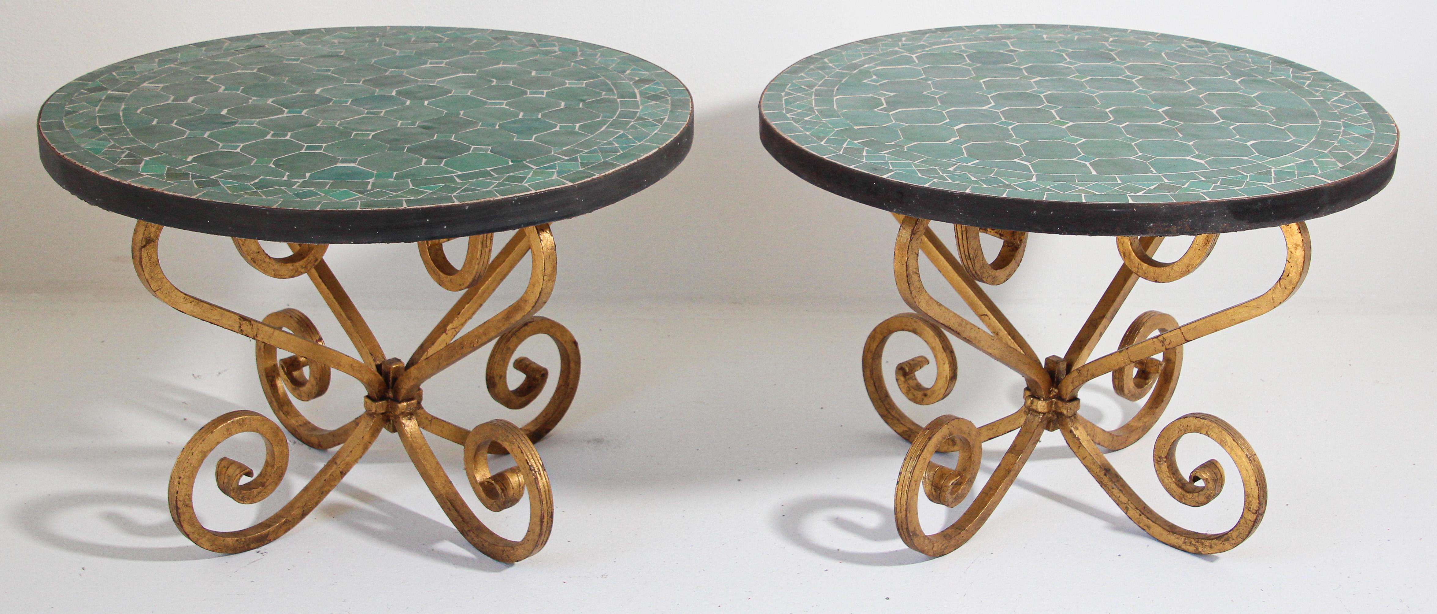 Pair of Moroccan mosaic Fez emerald green tiles side tables on heavy gilt iron forged scrolled base.
Handmade by expert artisans in Fez, Morocco using reclaimed old glazed emerald green colors tiles inlaid in concrete and making beautiful