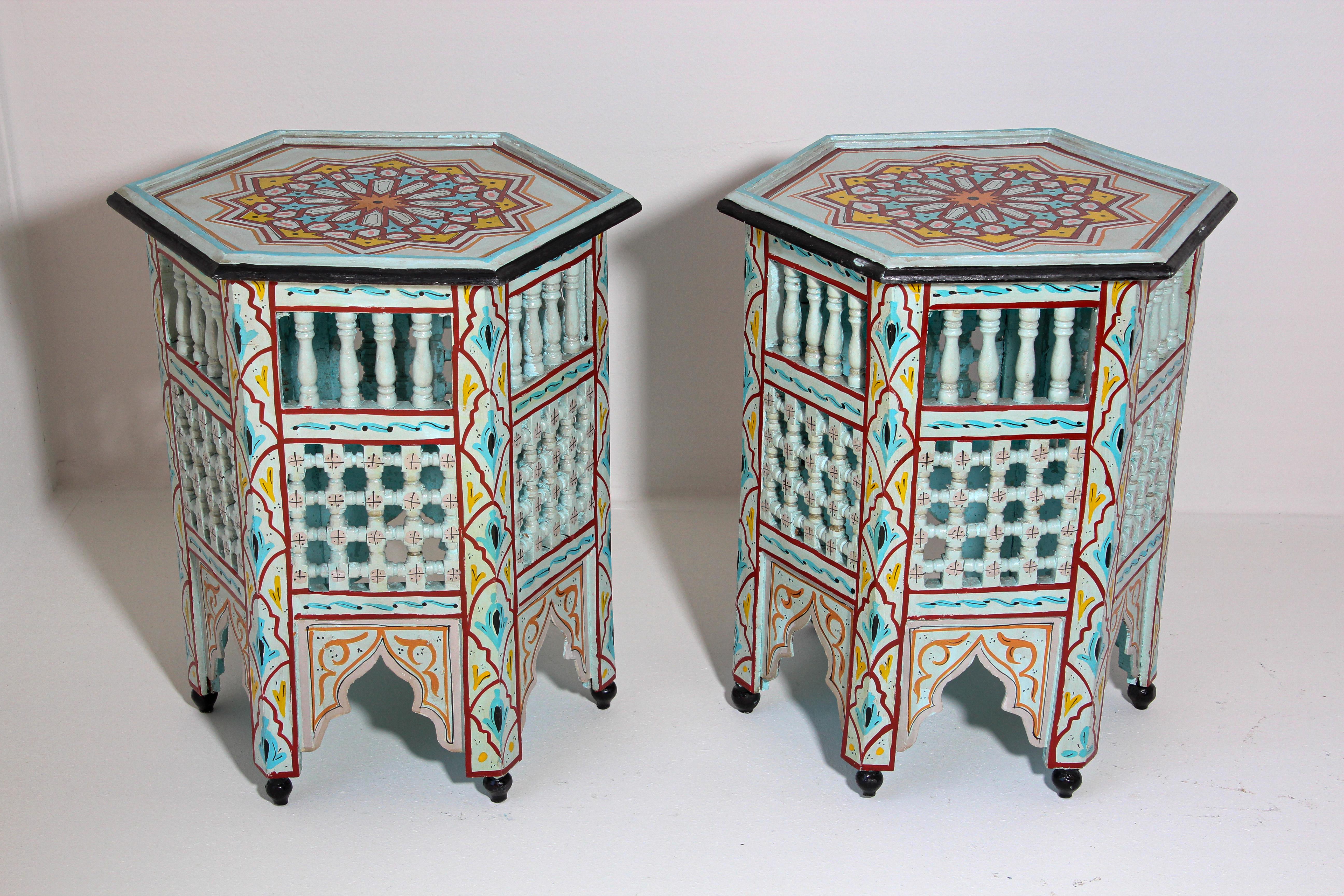 Pair of Moroccan handcrafted and hand painted tabourets or side tables.
Moucharabie fret work octagonal stools with Moorish arches.
Handcrafted in Hispano Moresque style and hand painted on vanilla color background with wine, aqua, black and ochre