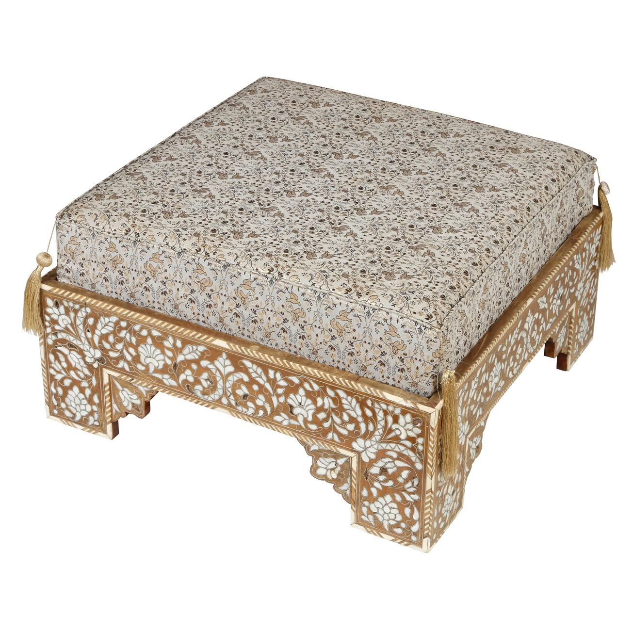 A pair of Moroccan style square ottomans with inlaid design on all sides.