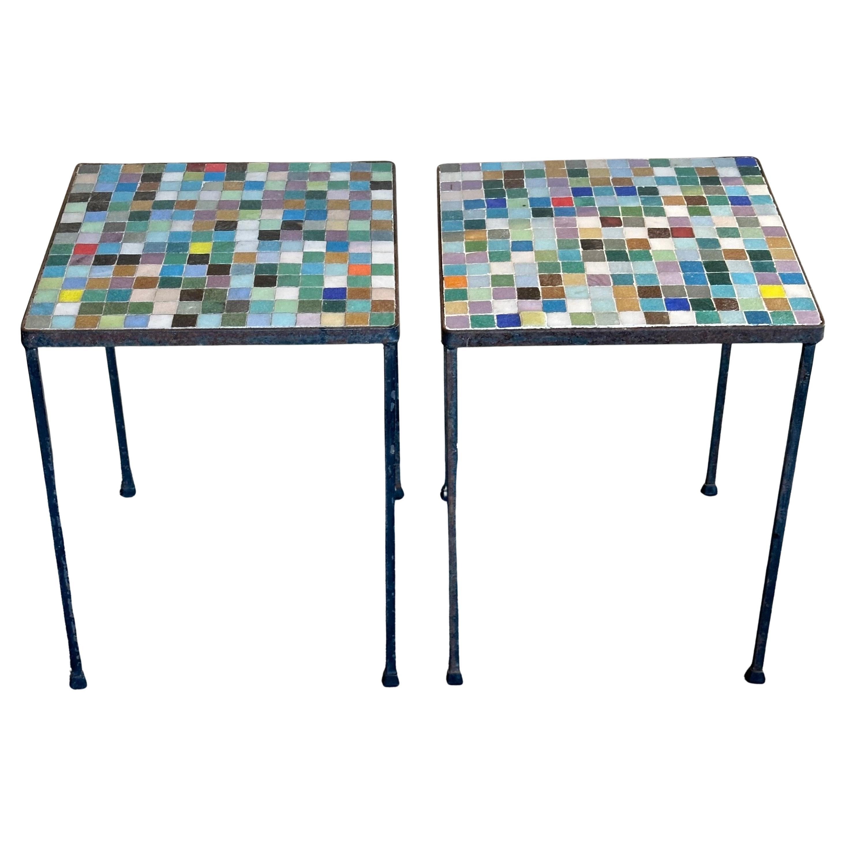 Vibrant pair of mosaic Italian art glass side tables in the style of Paul McCobb, circa 1960s. The tables have a rustic black iron base with mosaic glass tile tops in a rainbow of colors  Tables offer a great look with 'minimalist' lines. They can