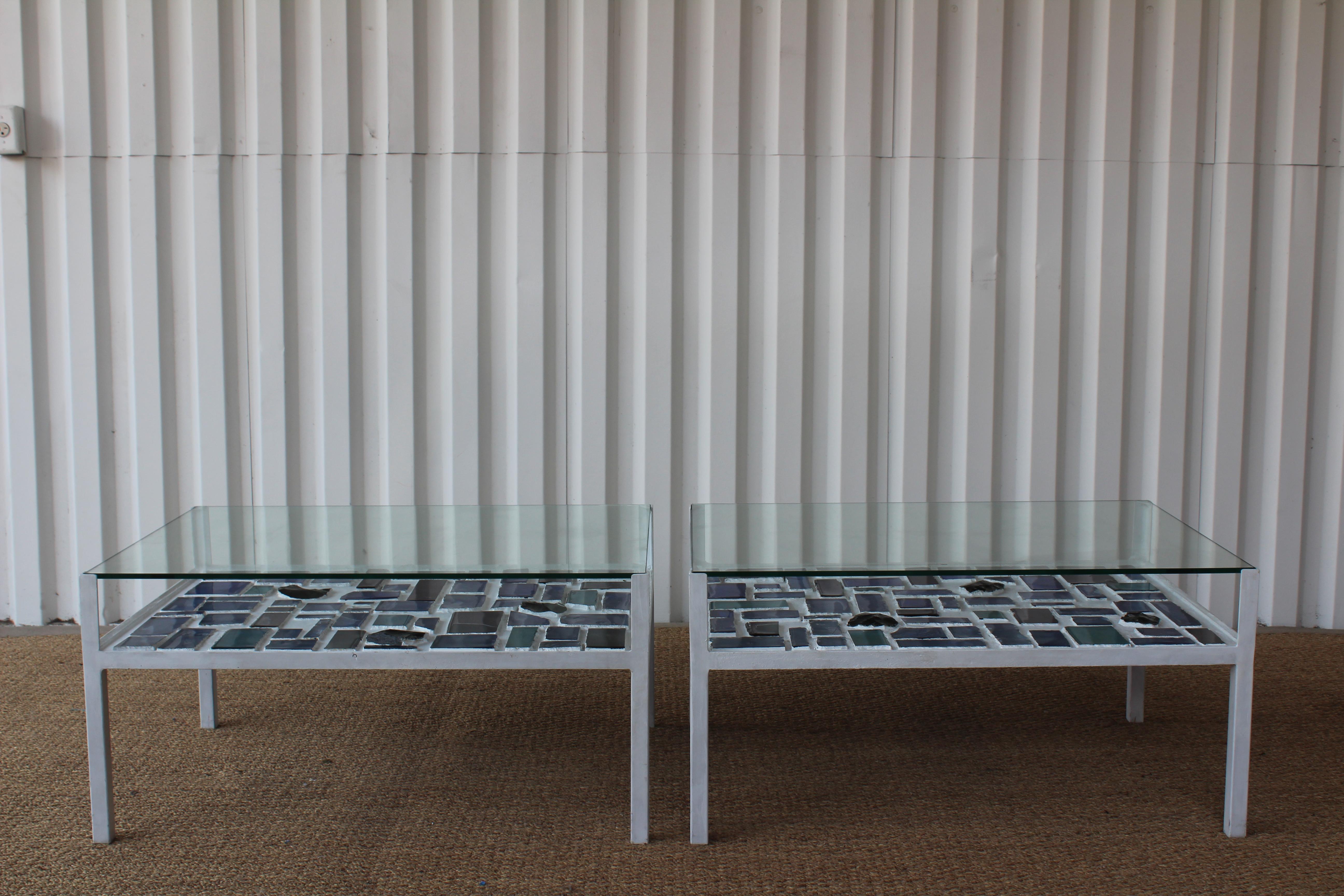 Pair of unique mosaic glass steel framed coffee tables or end tables with glass tops. These were most likely custom made with vintage M. Mellini Italian stained glass dating to 1974. The steel frames are in a painted in a gesso finish. The tops have