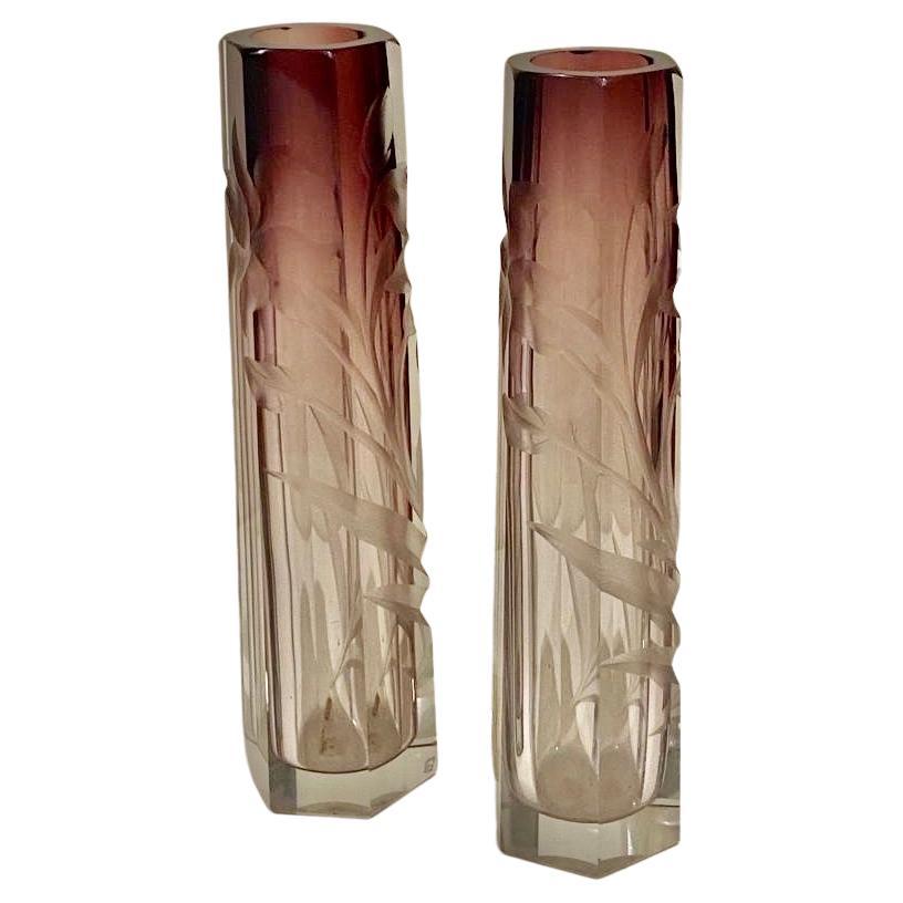 A amethyst-to-clear cut and engraved pair of glass Vases by Moser:
of hexhagenal tapering form deeply cut and etched with design of flowers and leaves; unsigned but guarateed to be by ‘Moser Karlsbad’.
The condition is excellent with no damage at