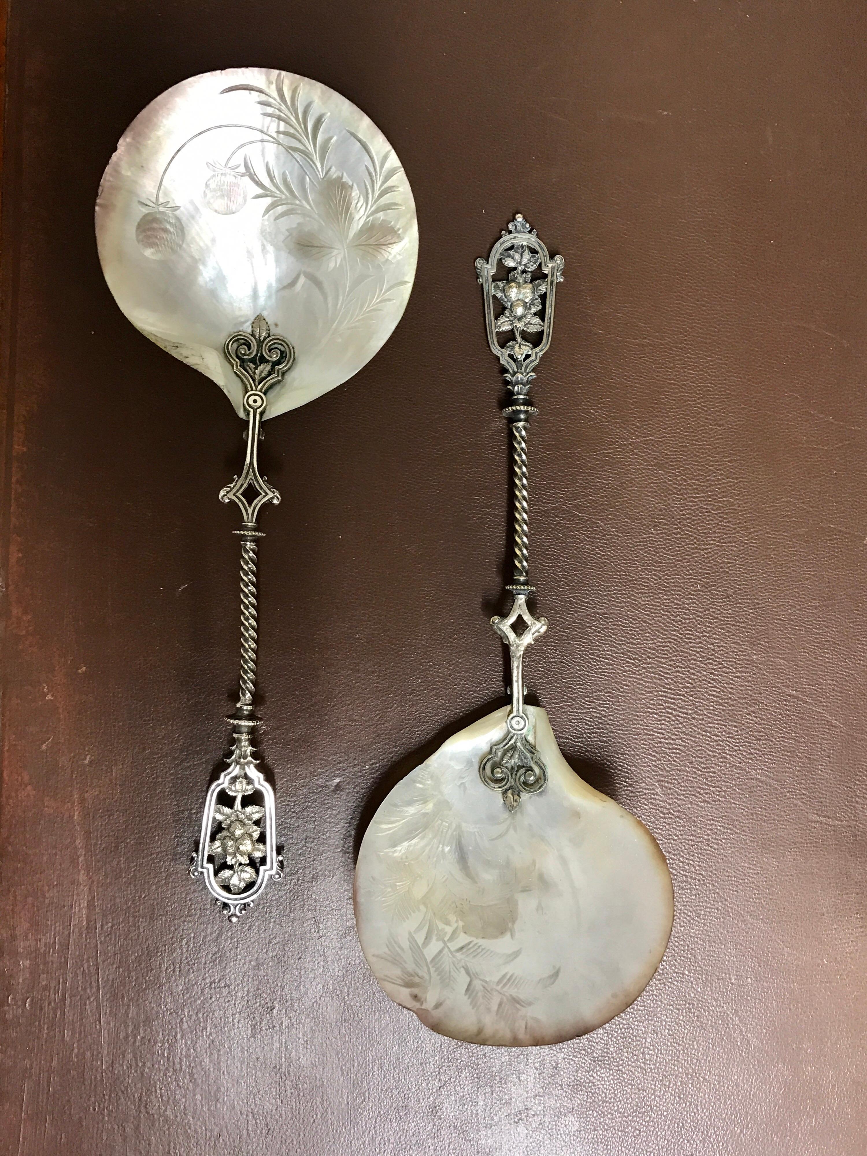 Pair of mother of pearl and silver strawberry spoons, each one with cast silver twisted handles with strawberries, and a 4