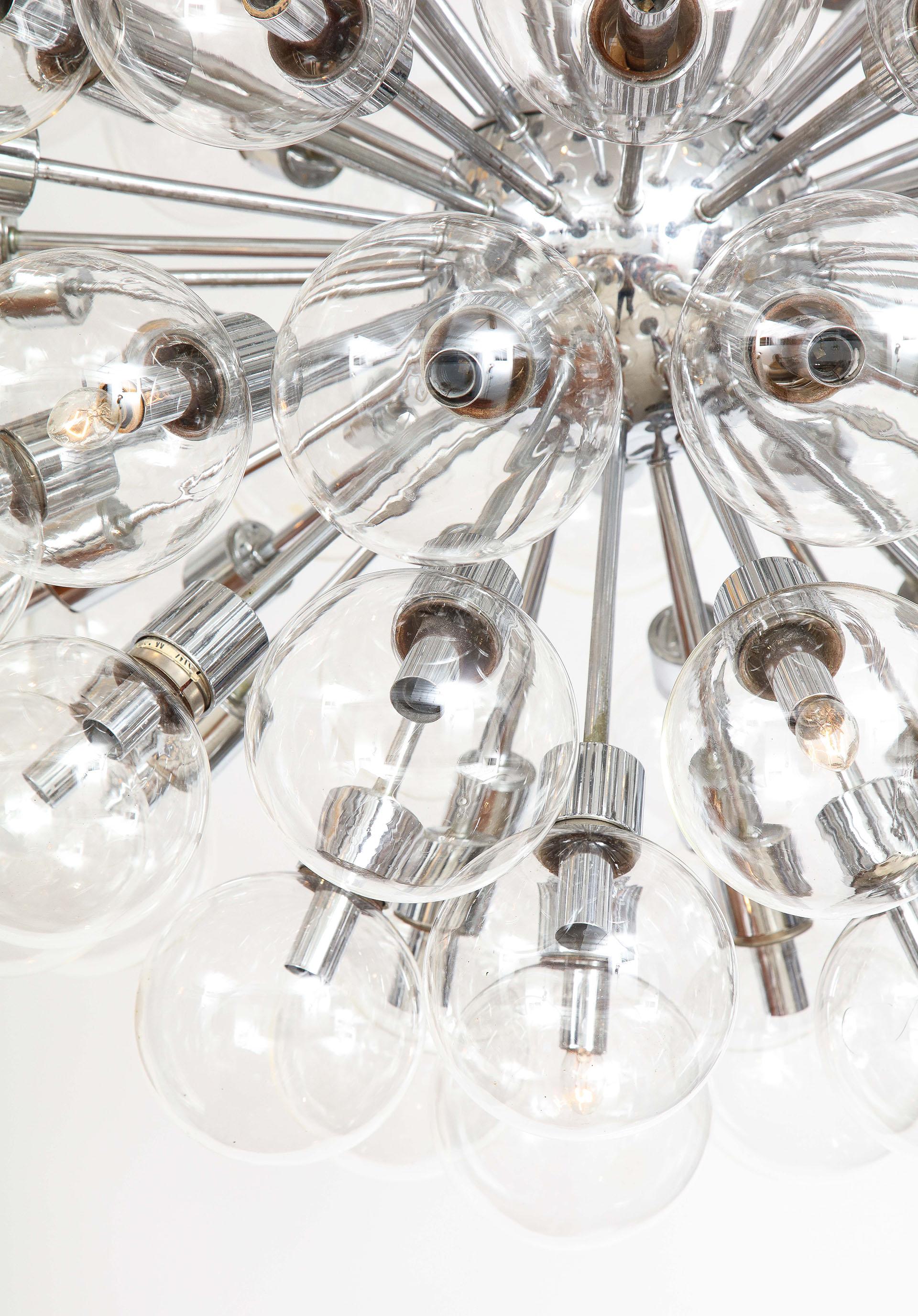 The pair of Mid-Century Modernist monumental polished chrome Sputnik chandeliers, each having 75 spherical clear blown glass globes. Design by Motoko Ishii & Manufactured by Staff Leuchten.
 