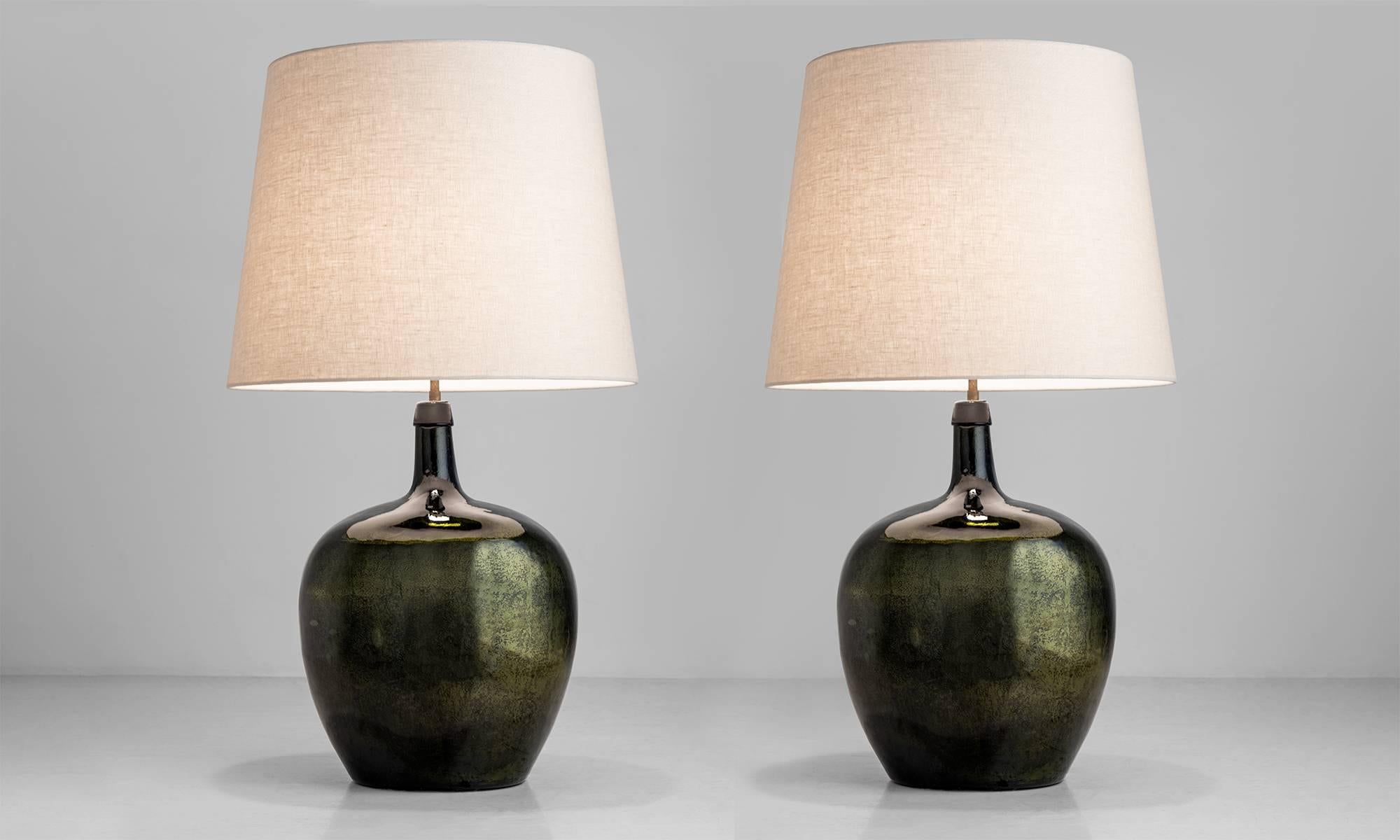 Pair of mottled mirrored lamps, England, circa 1940.

Base originally used as a chemical storage bottle features a beautiful patina and surface. Includes newly made shade.