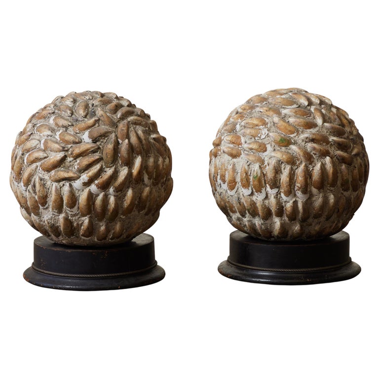Pair of mounted spherical shell sculptures, 1920