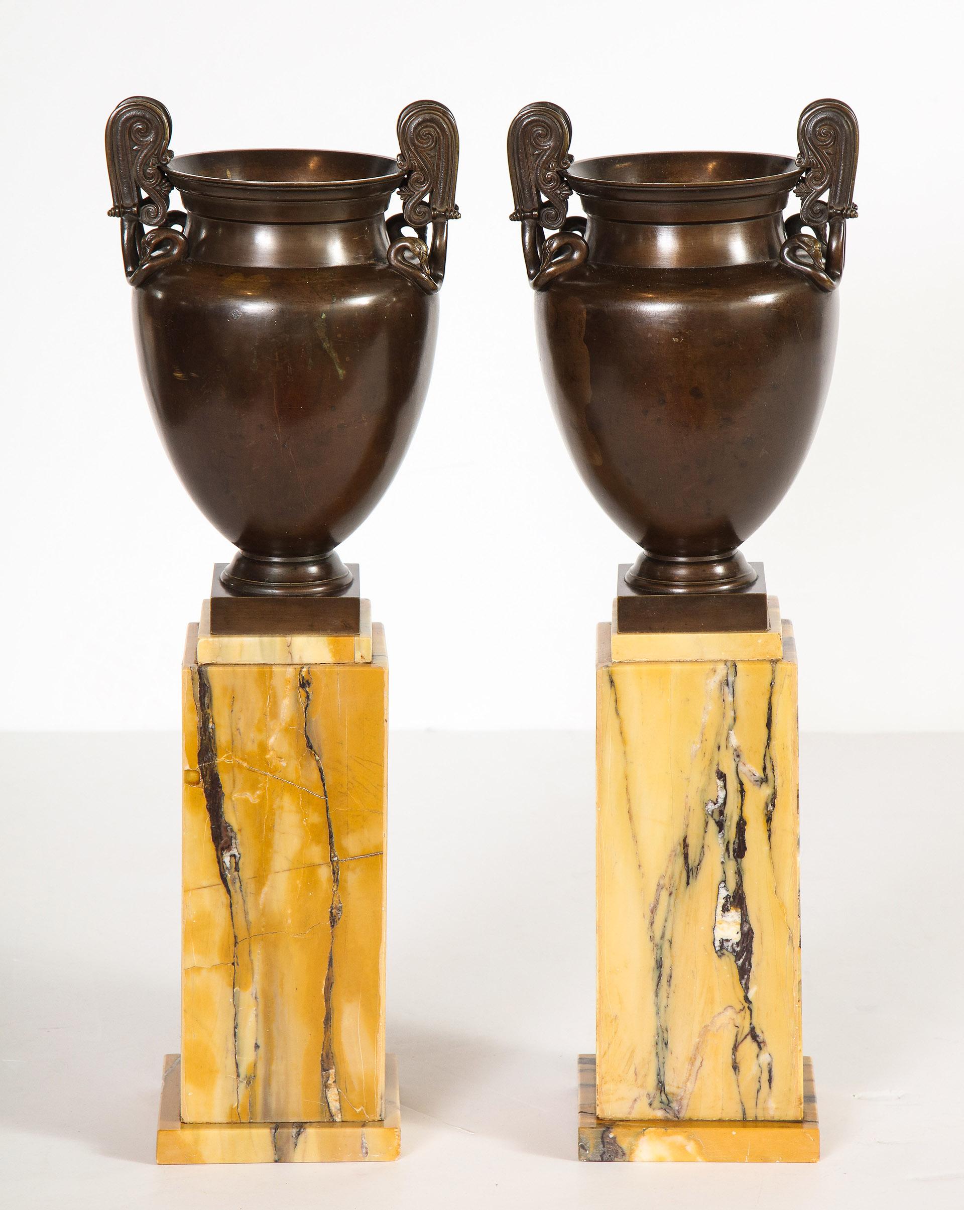 Bronze Pair of Mounted Urns For Sale