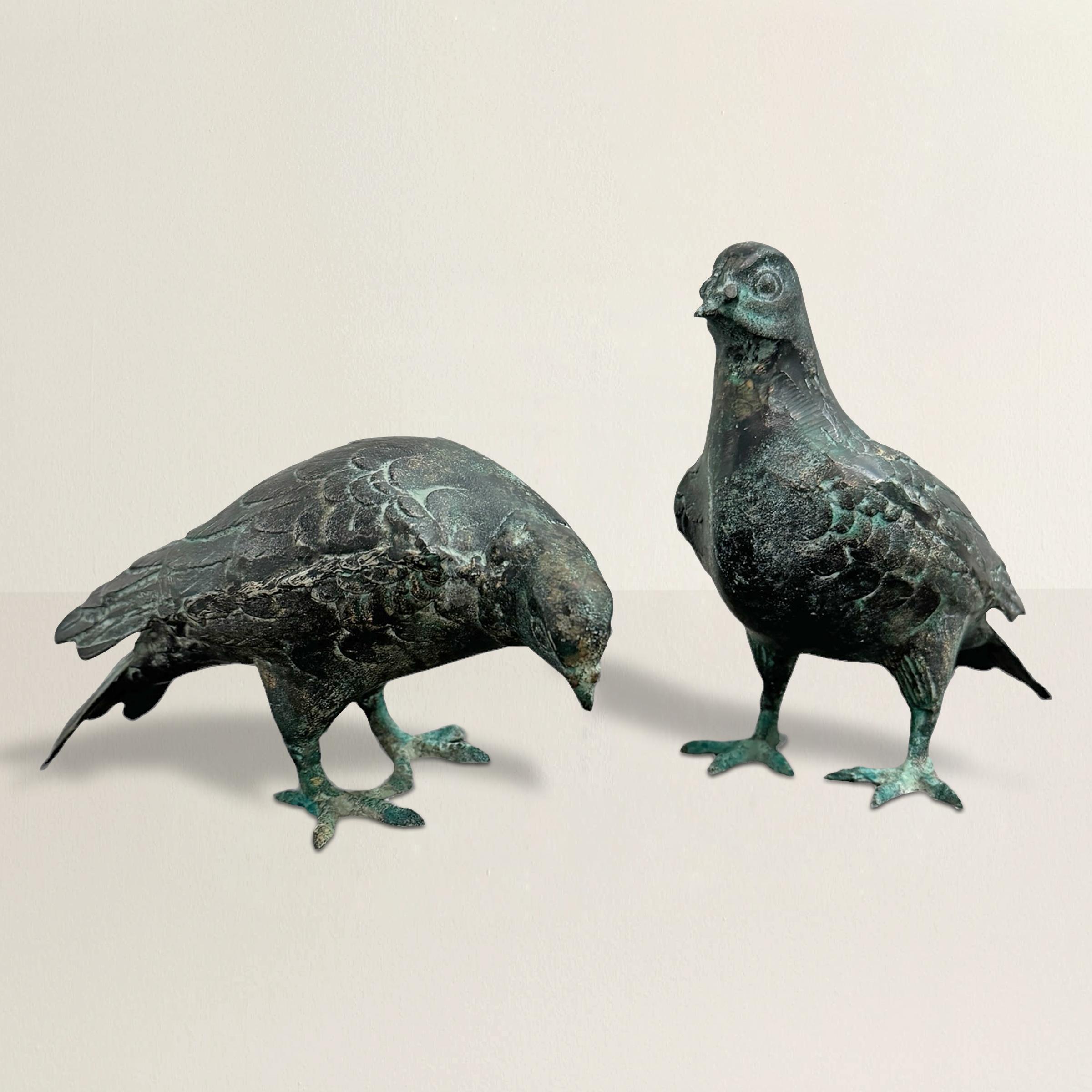 This exquisite pair of 20th-century cast metal Mourning Doves features one bird standing upright and the other gracefully bent over, designed to elegantly peer over the edge of a bookshelf or fireplace mantle. The doves are finished with a verdigris