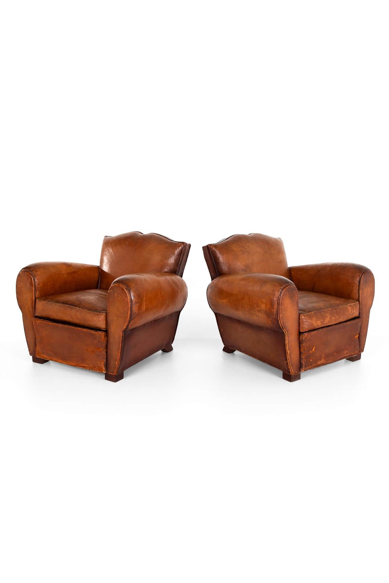 A wonderful pair of moustache back club chairs.

Generous cigar arms with deep seats over stuffed scroll backs.

Upholstered in a beautiful thick chestnut leather and raised on oak block feet.

Fully restored with new webbing and springs replaced