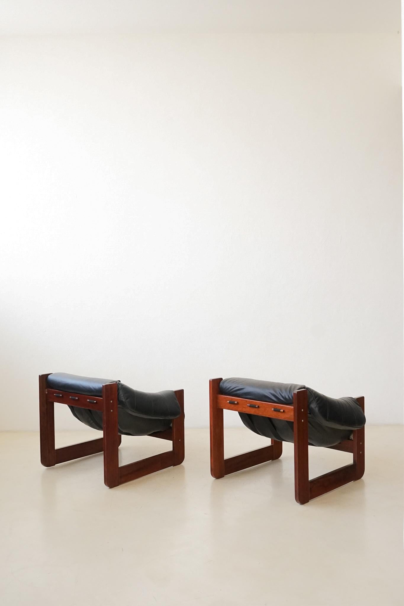 In his designs, Percival Lafer sought ergonomy and comfort. This pair of MP-97 lounge chairs by Percival Lafer comprises a solid wood structure with a single piece of a loose foam seat. Its unique design and construction make this an authentic