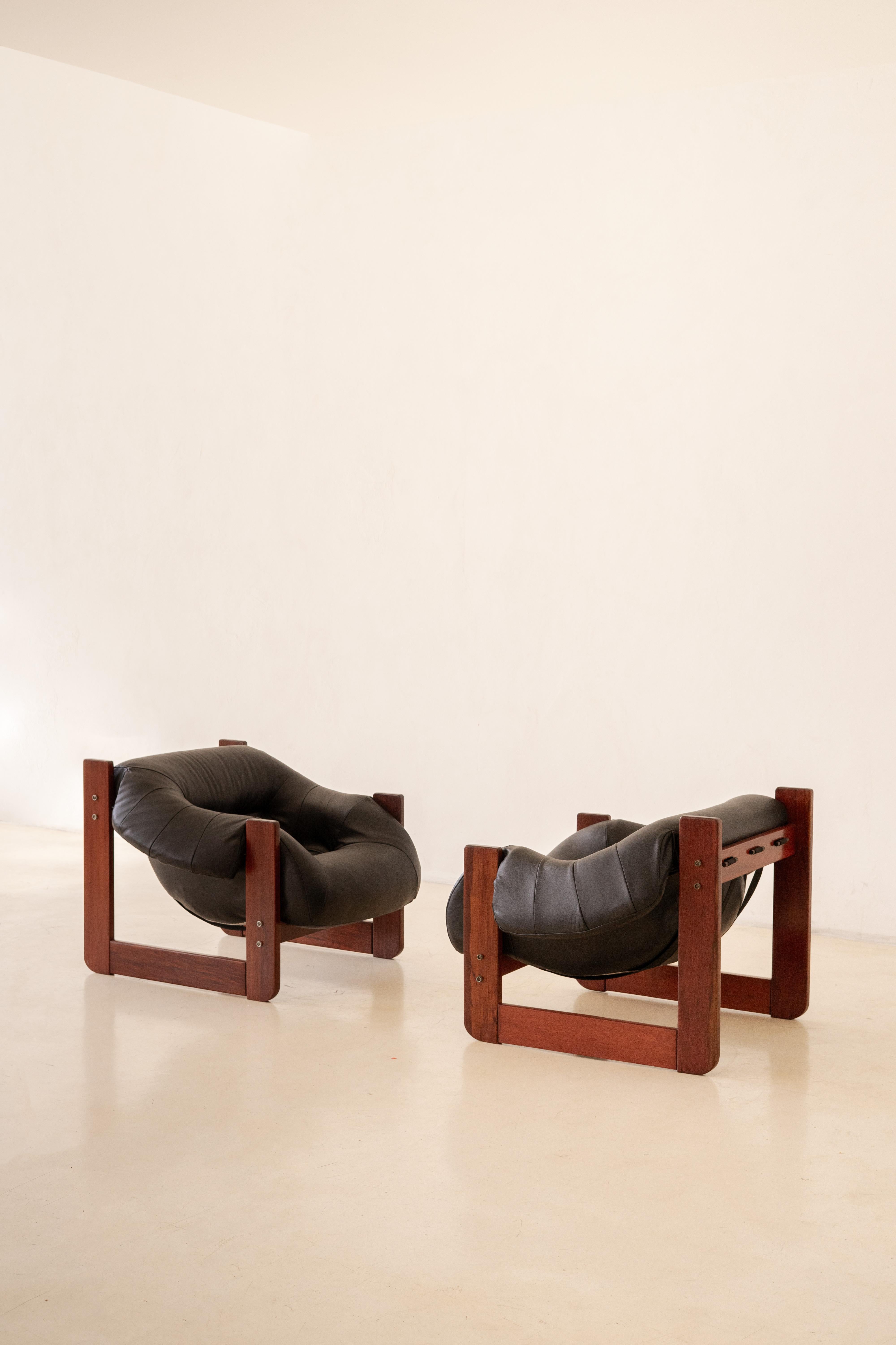 In his designs, Percival Lafer sought ergonomy and comfort. This pair of MP-97 lounge chairs by Percival Lafer comprises a solid wood structure with a single piece of a loose foam seat. Its unique design and construction make this an authentic